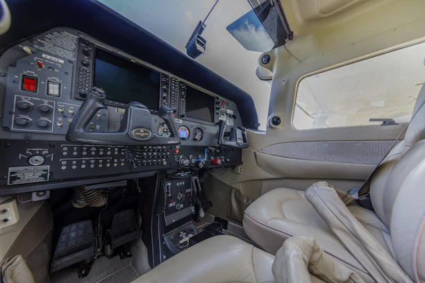 Airplane cockpit with seats and control panel.