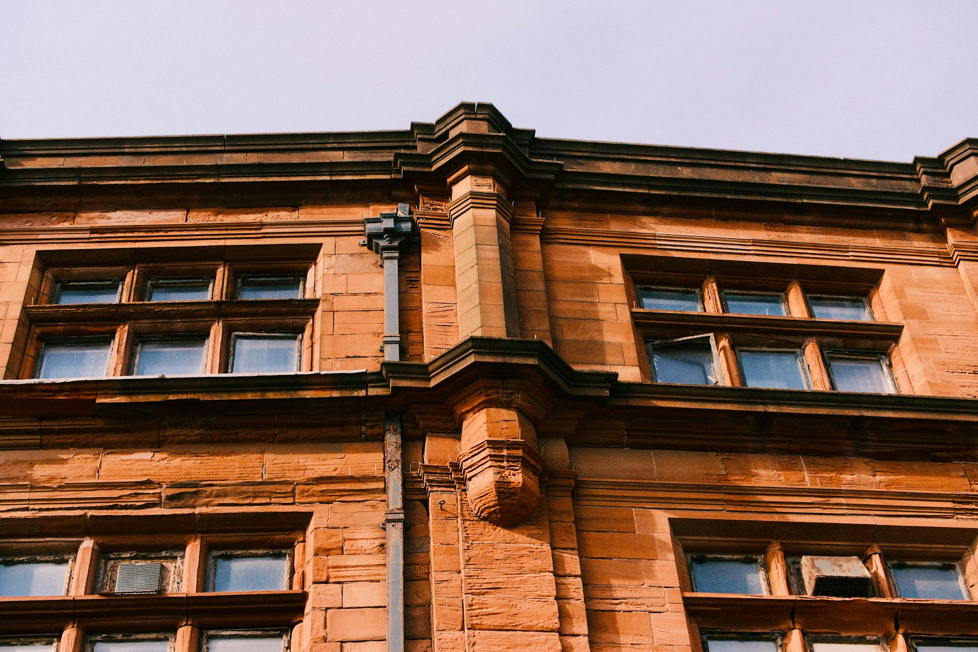 Close-up of an old brick building with windows.