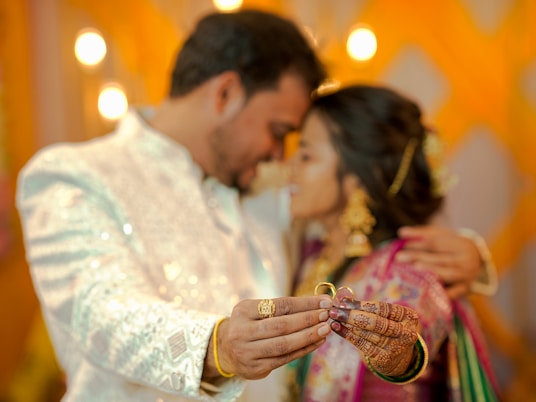 Couple holding rings during a ceremony