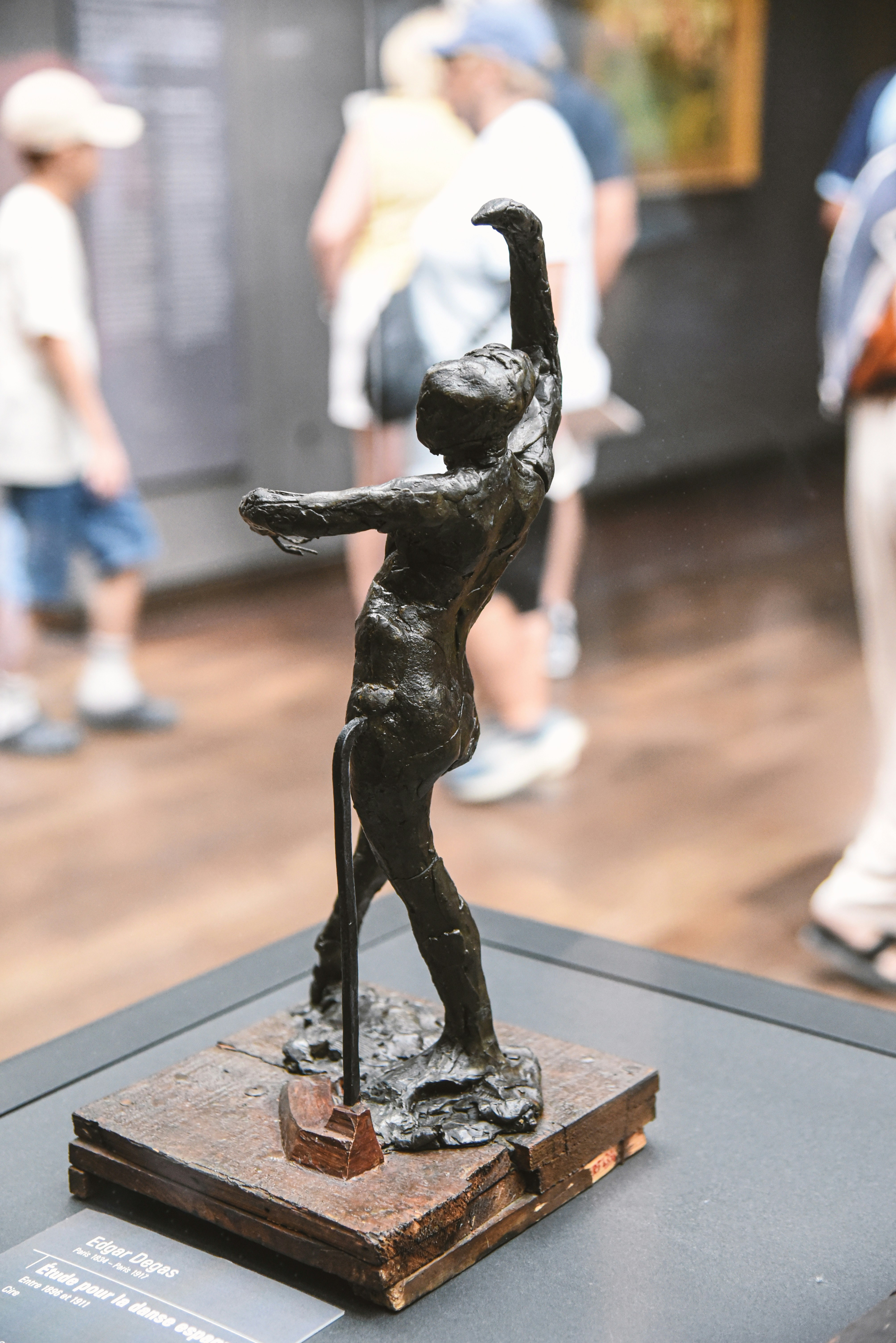 Bronze sculpture of a dancer on a wooden base