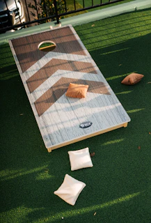 Cornhole boards and bags on green turf