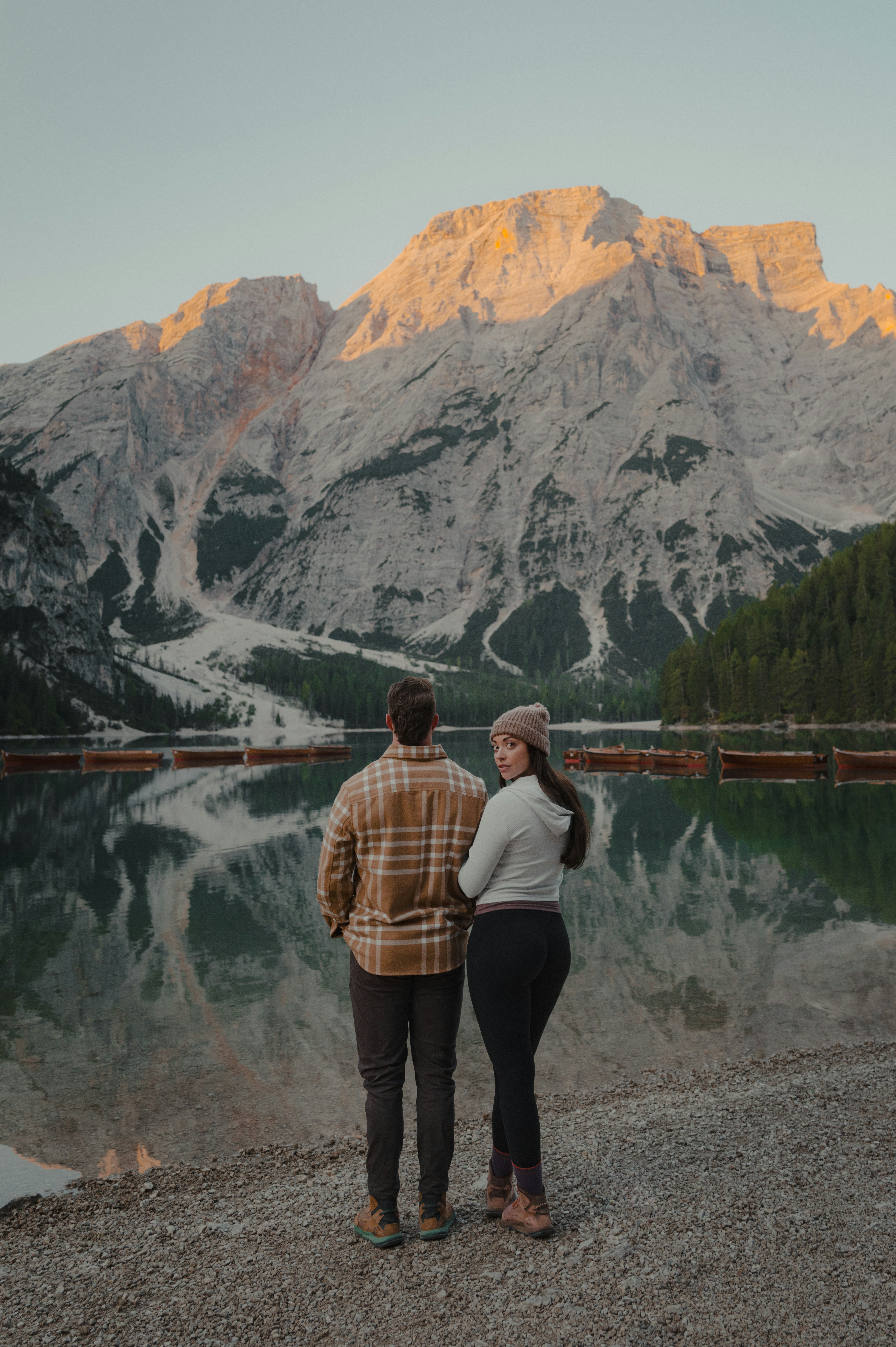 Couple standing by a lake with mountains