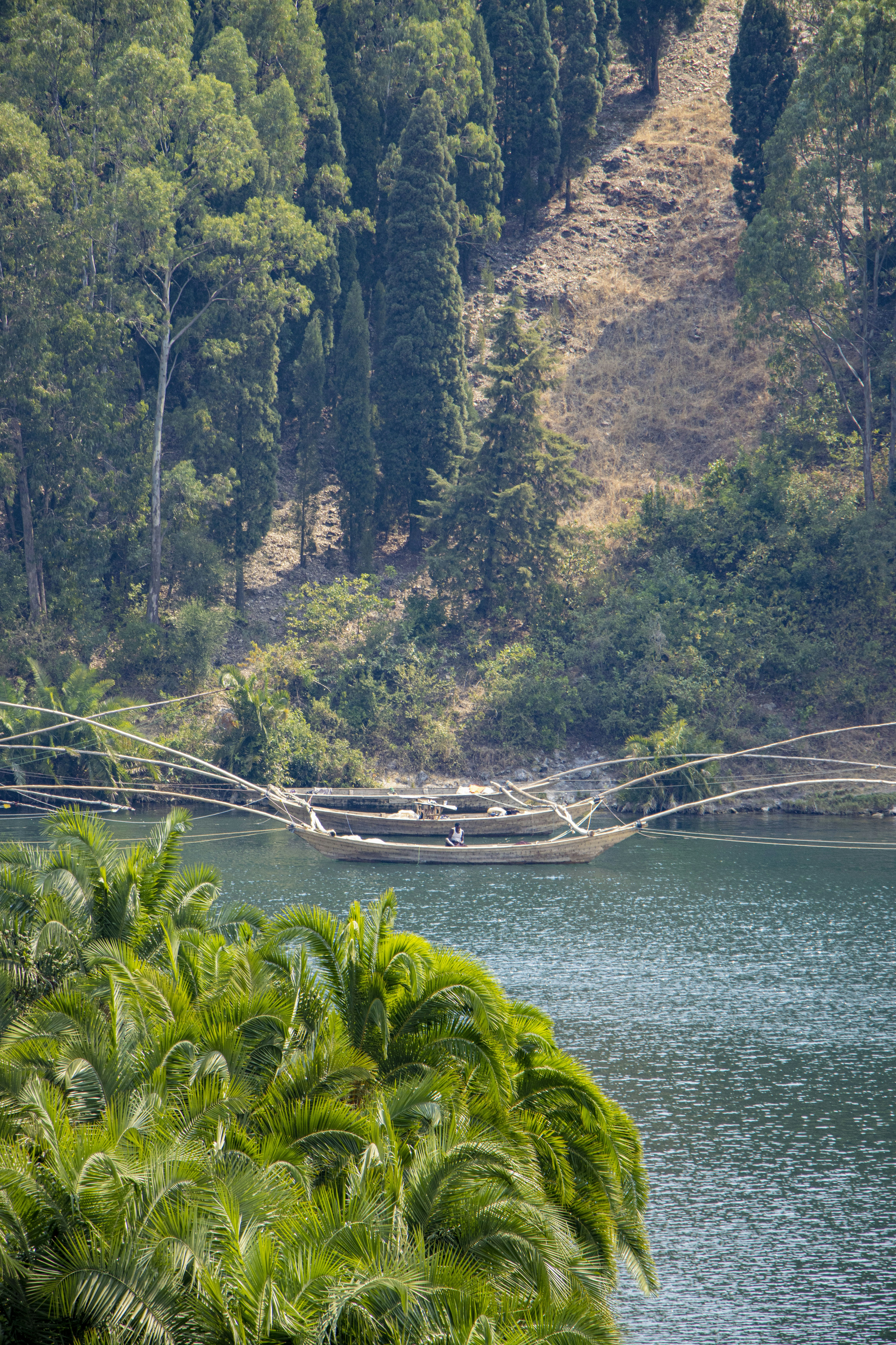 Boat with fishing nets on a calm lake