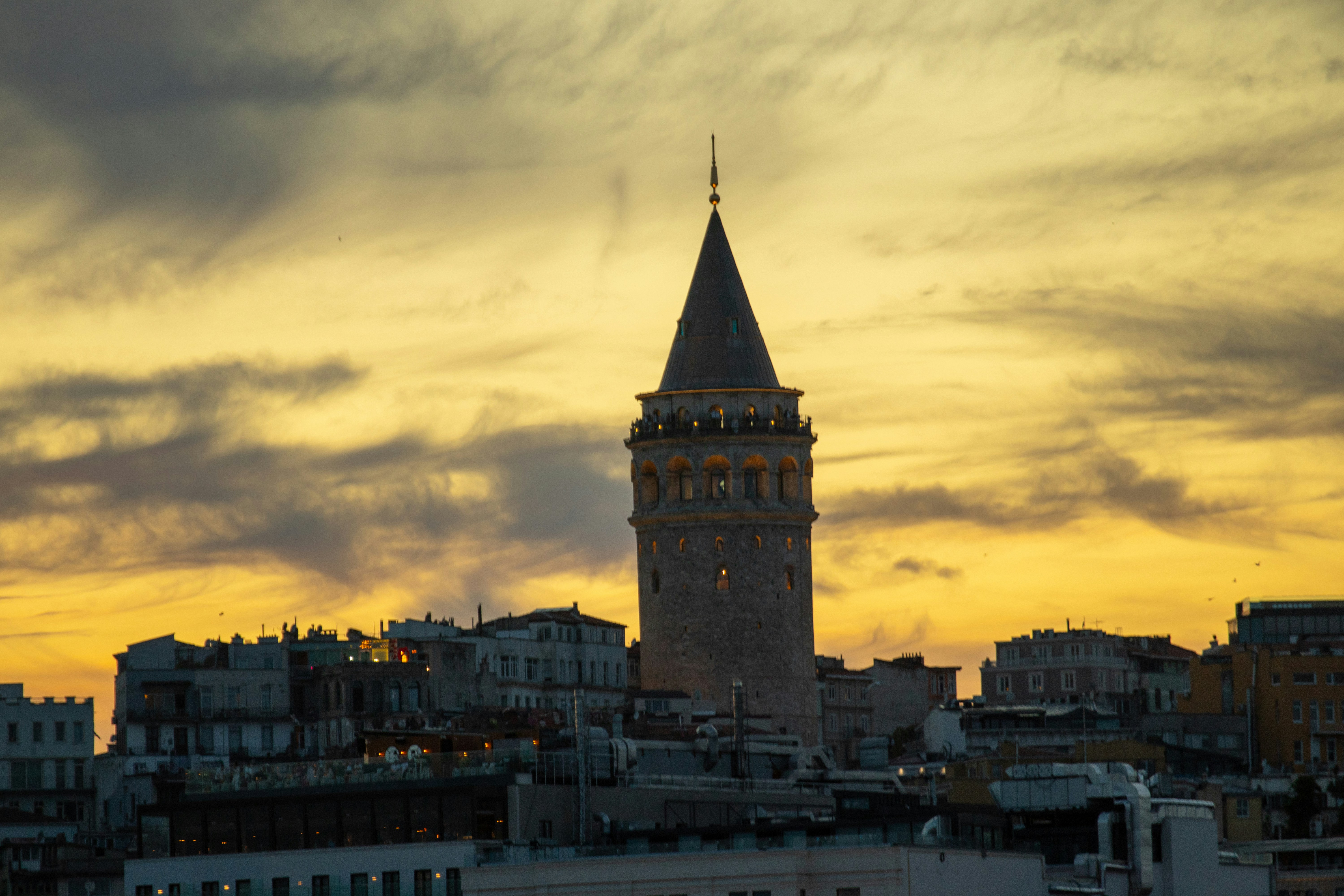 Galata tower against a dramatic sunset sky