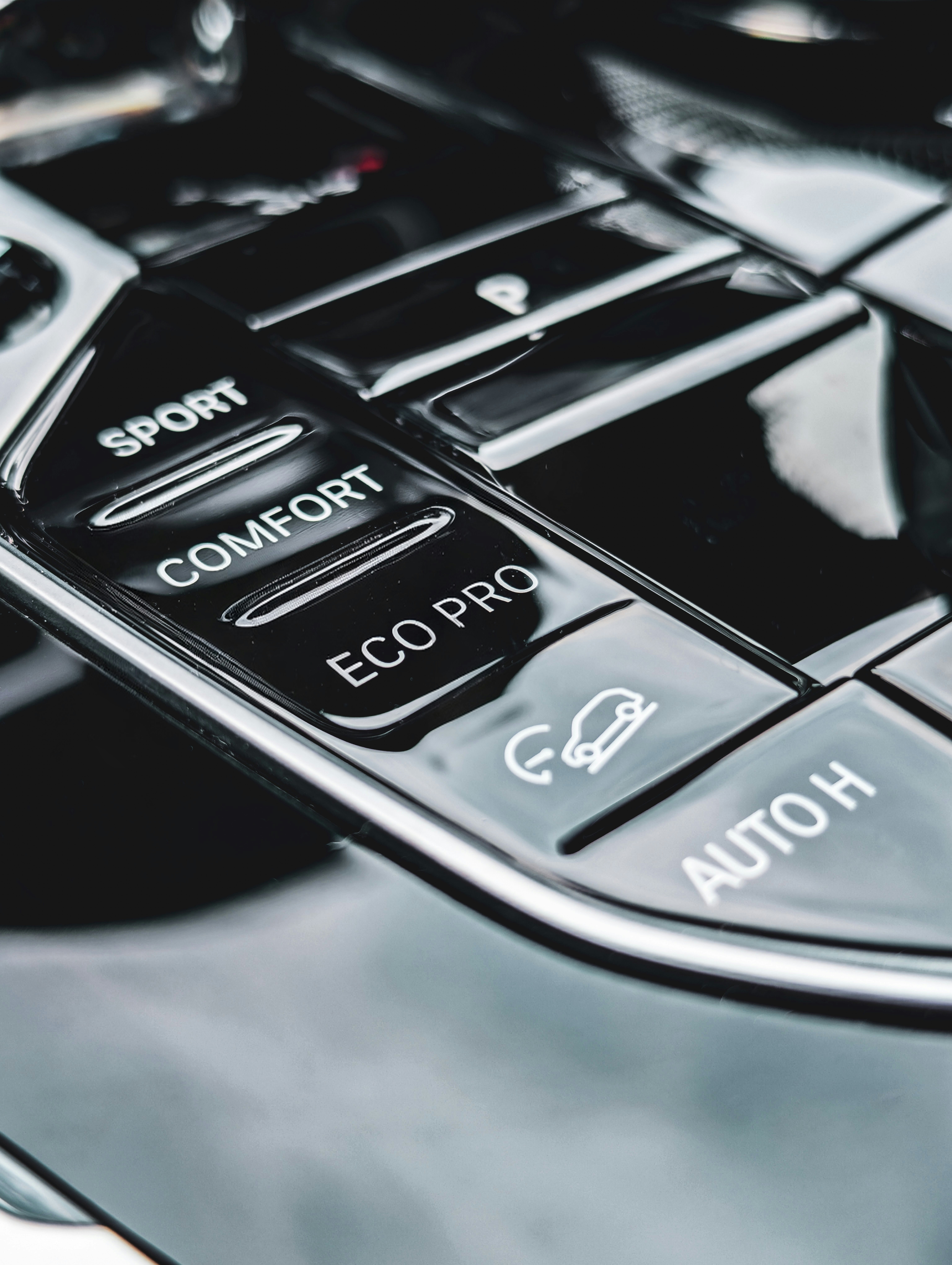 Car interior with driving mode selection buttons.