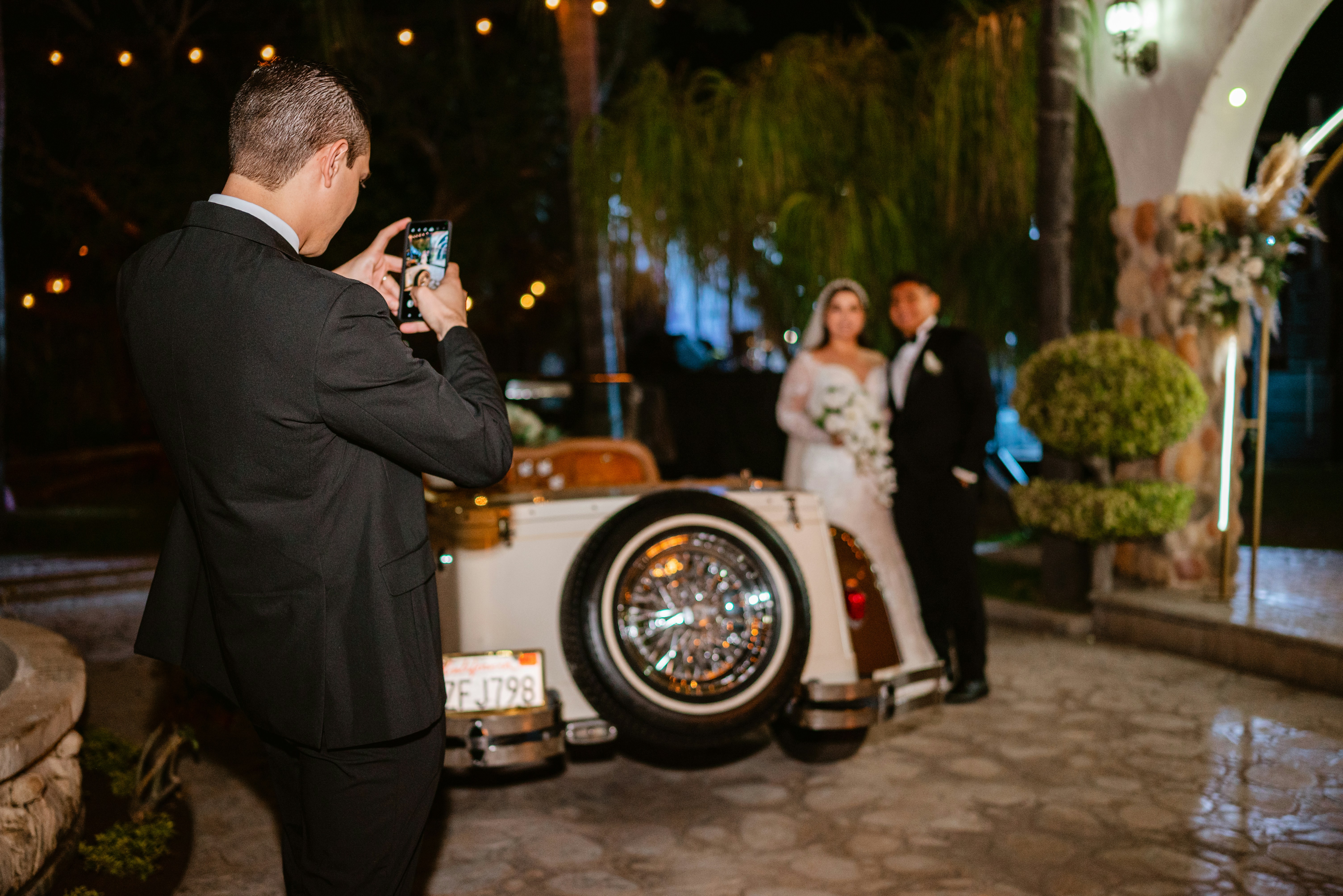 Professional wedding photographer with vintage car