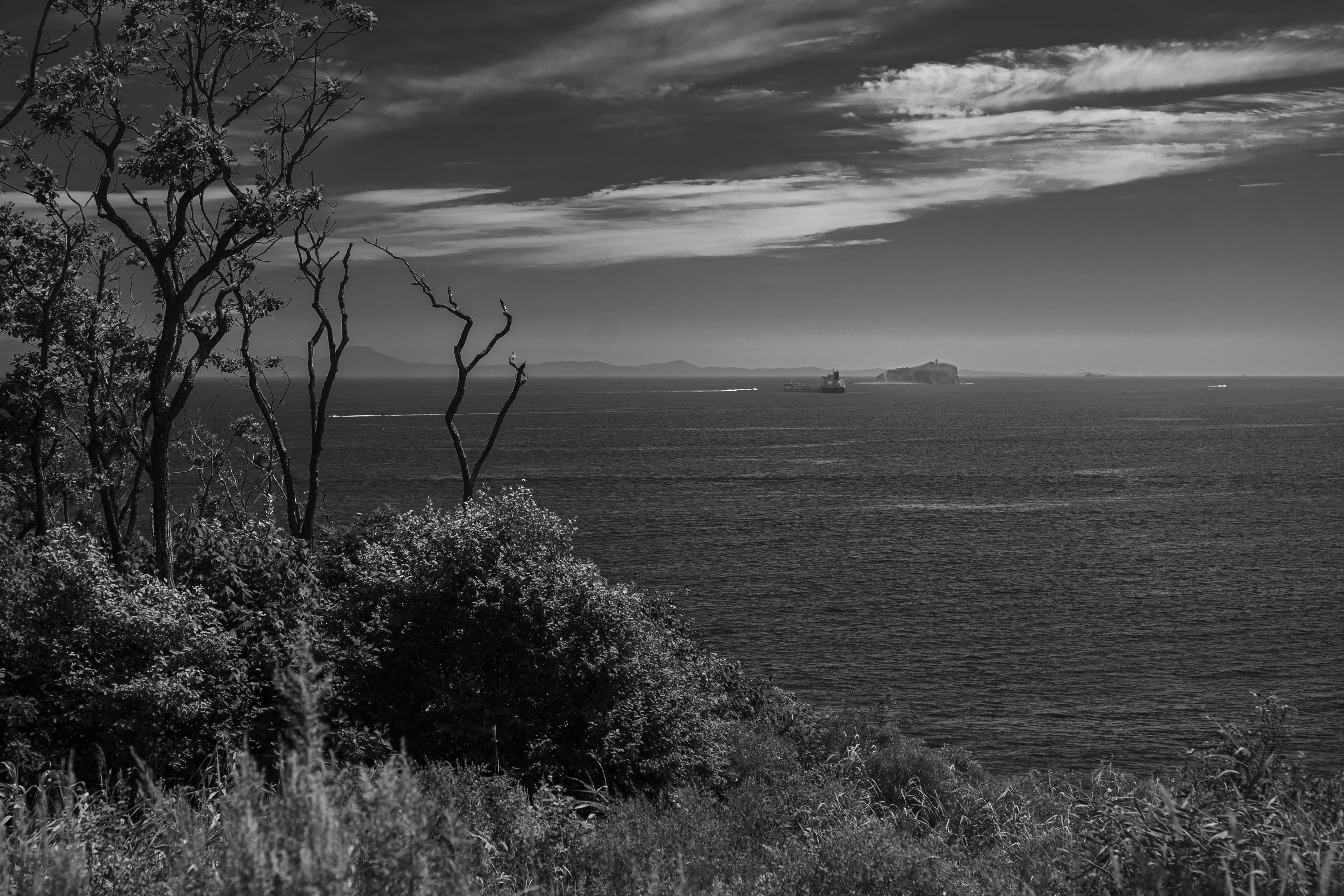 View of the ocean with islands and clouds.
