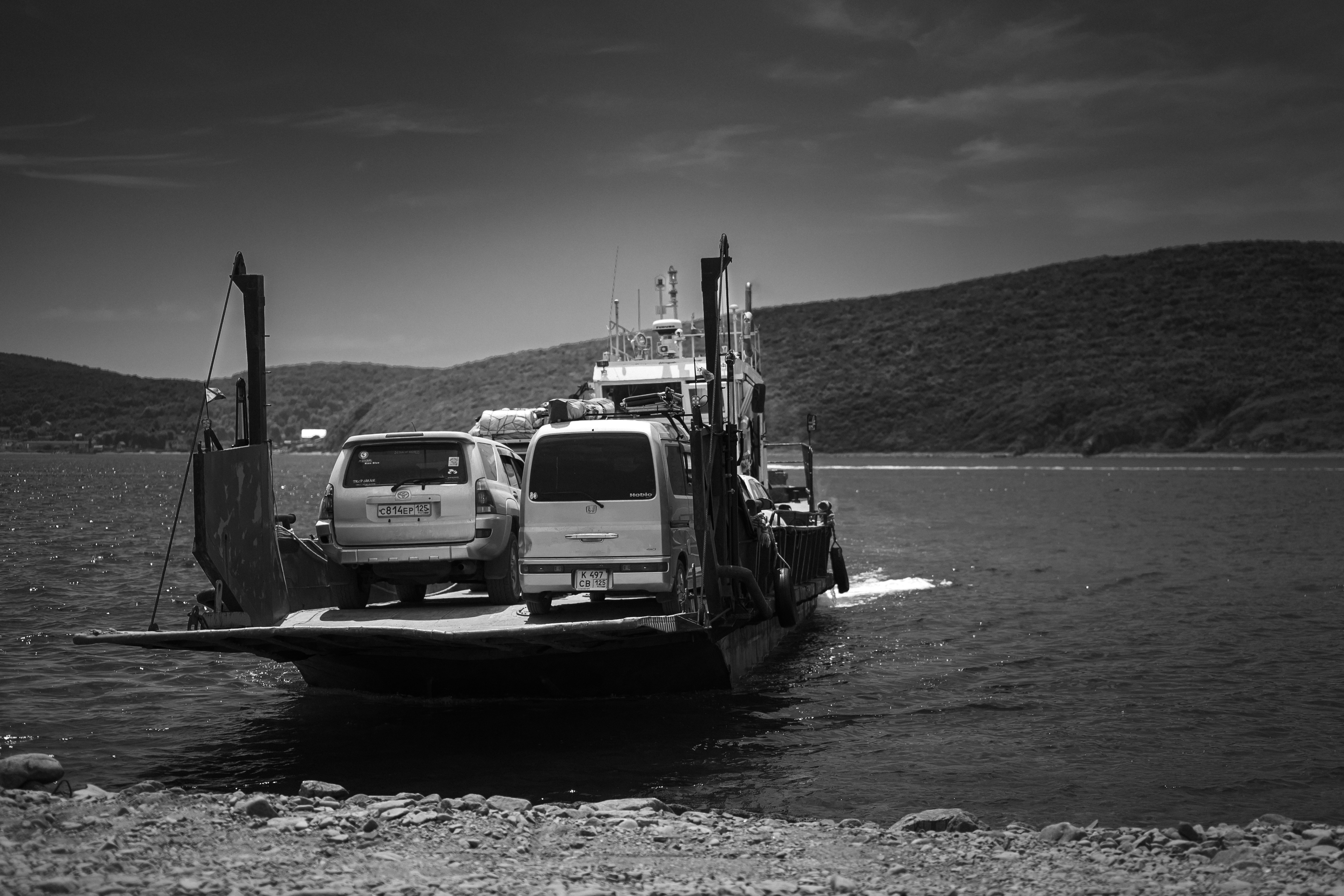 Cars on a ferry crossing a body of water
