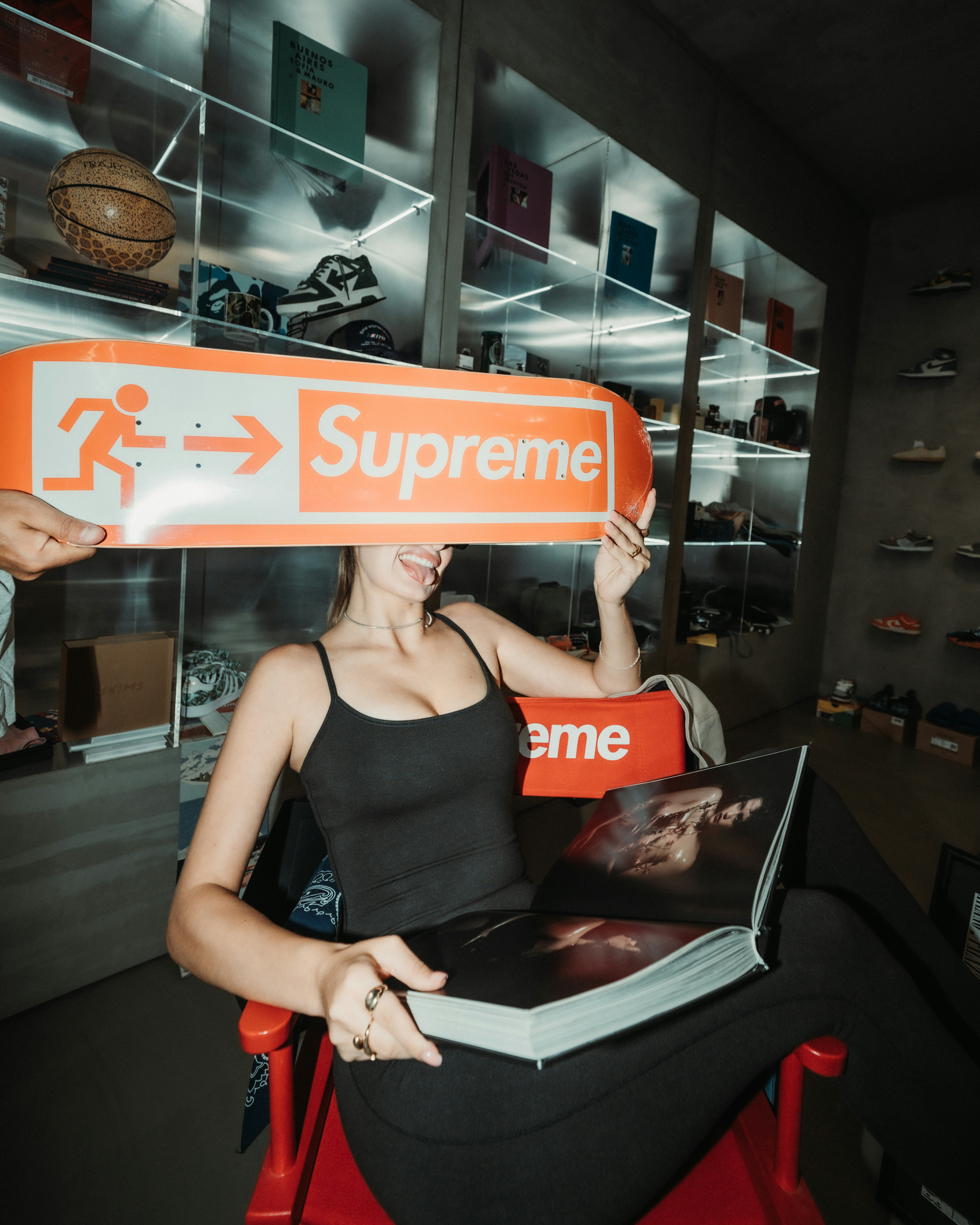 Supreme in one hand, a book in the other, two words colliding in one cinematic frame.