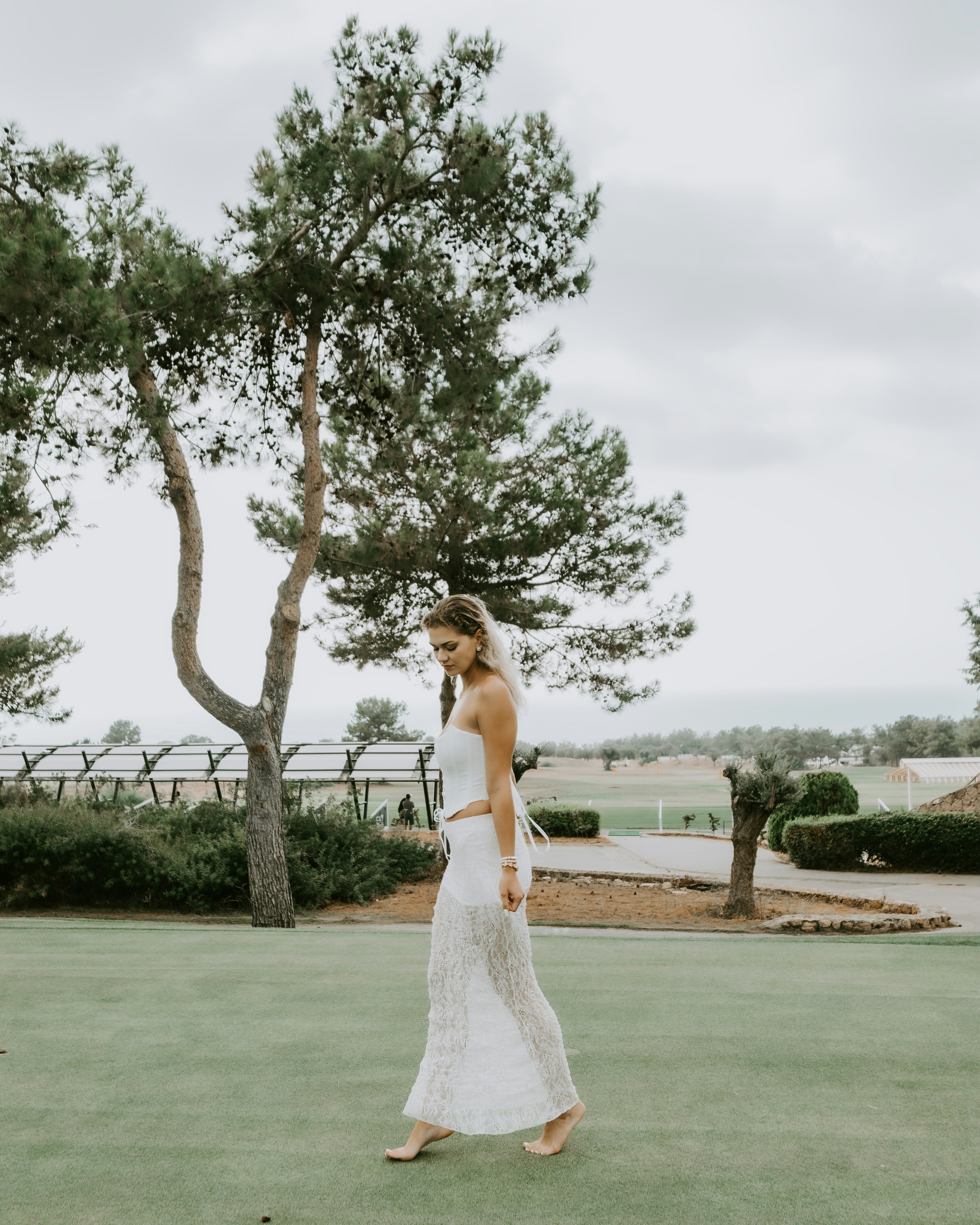 Woman in white dress walking on grass