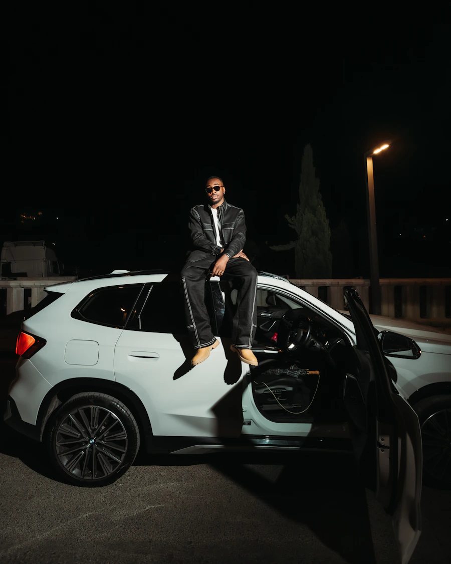 Man wearing dark streetwear in a night editorial setting