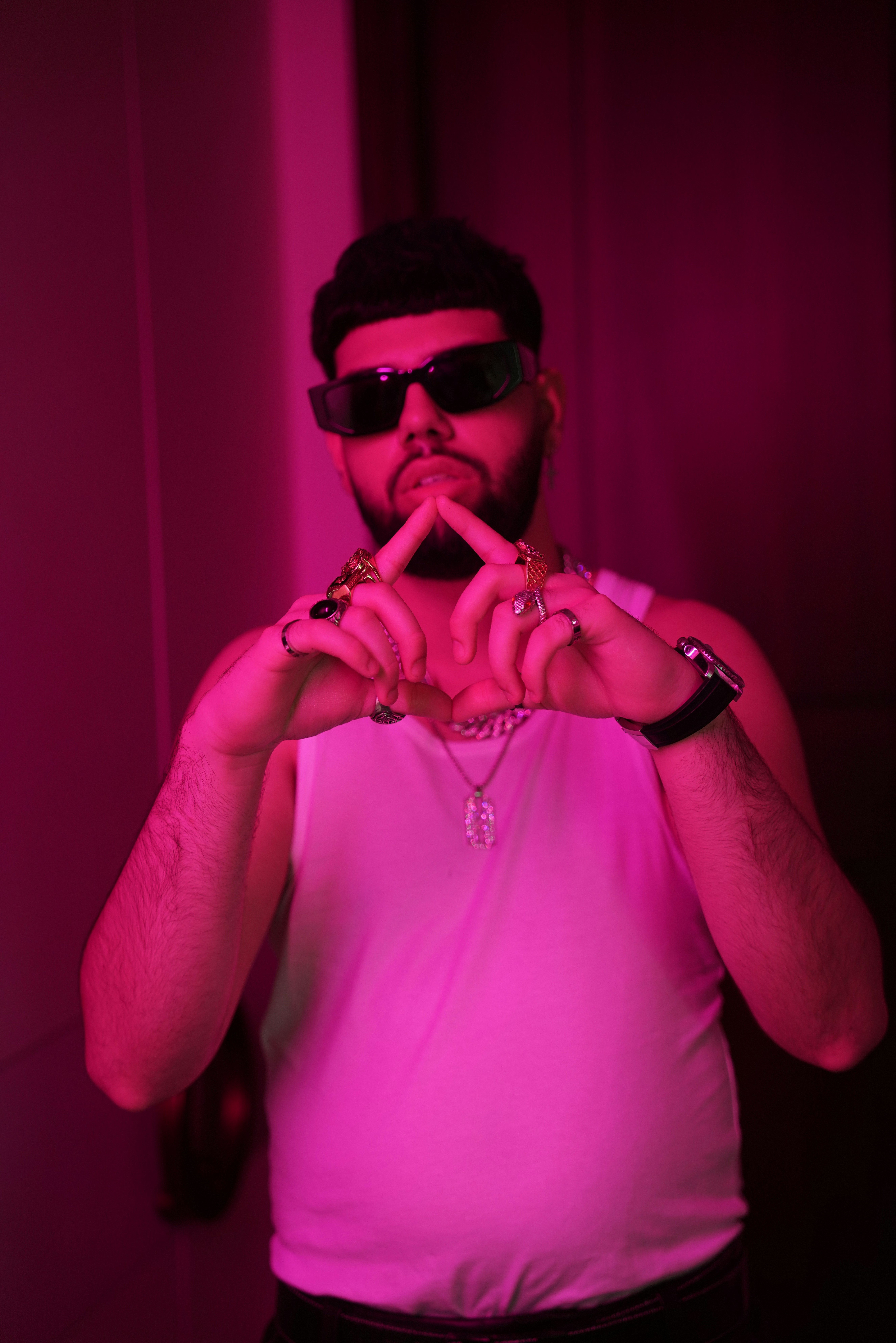 Man in sunglasses and tank top with jewelry