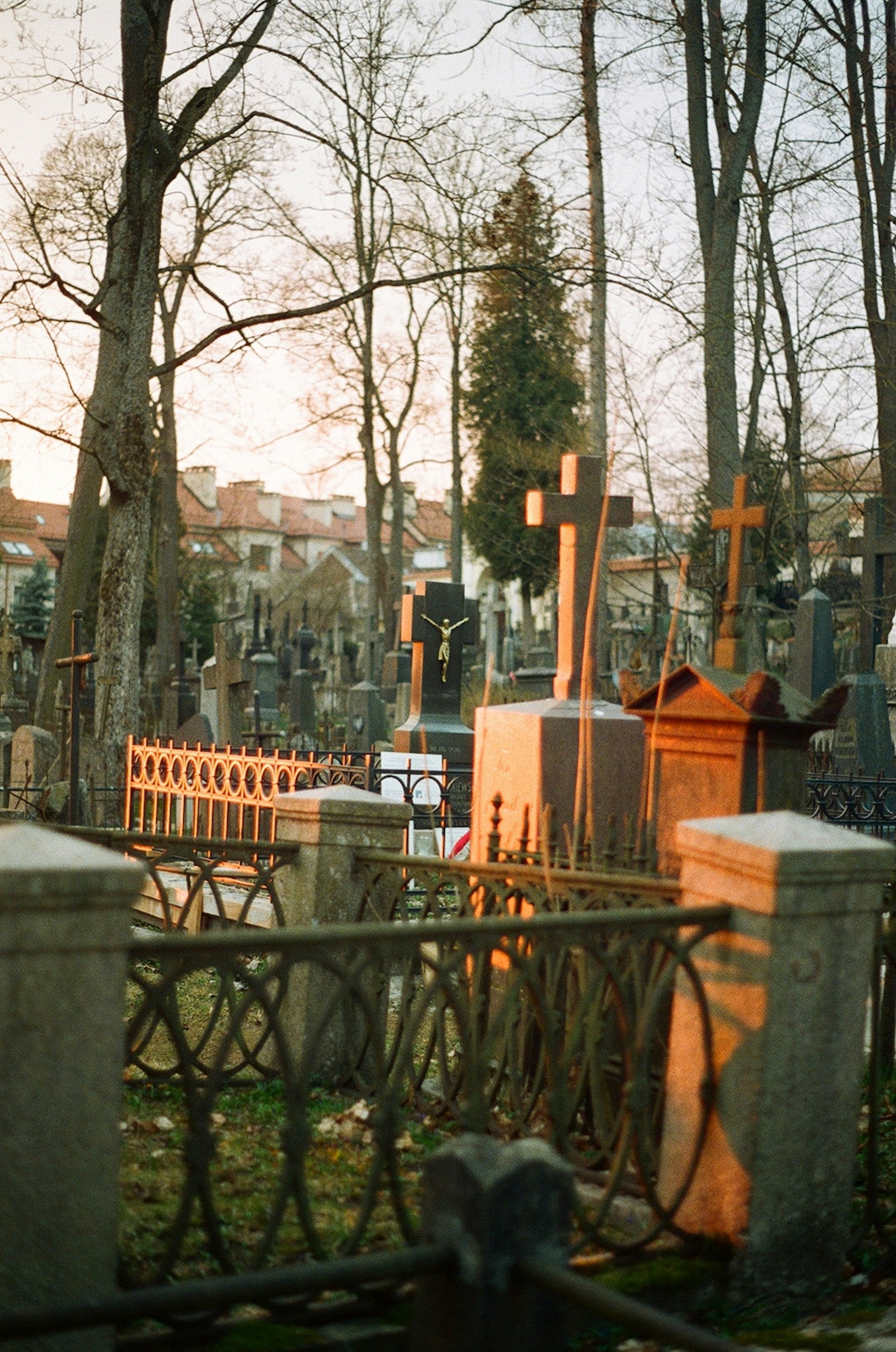 Cemetery with gravestones and crosses at sunset