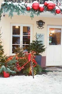 Building entrance decorated for christmas with snow.