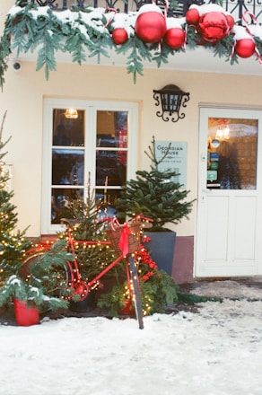 Building entrance decorated for christmas with snow.