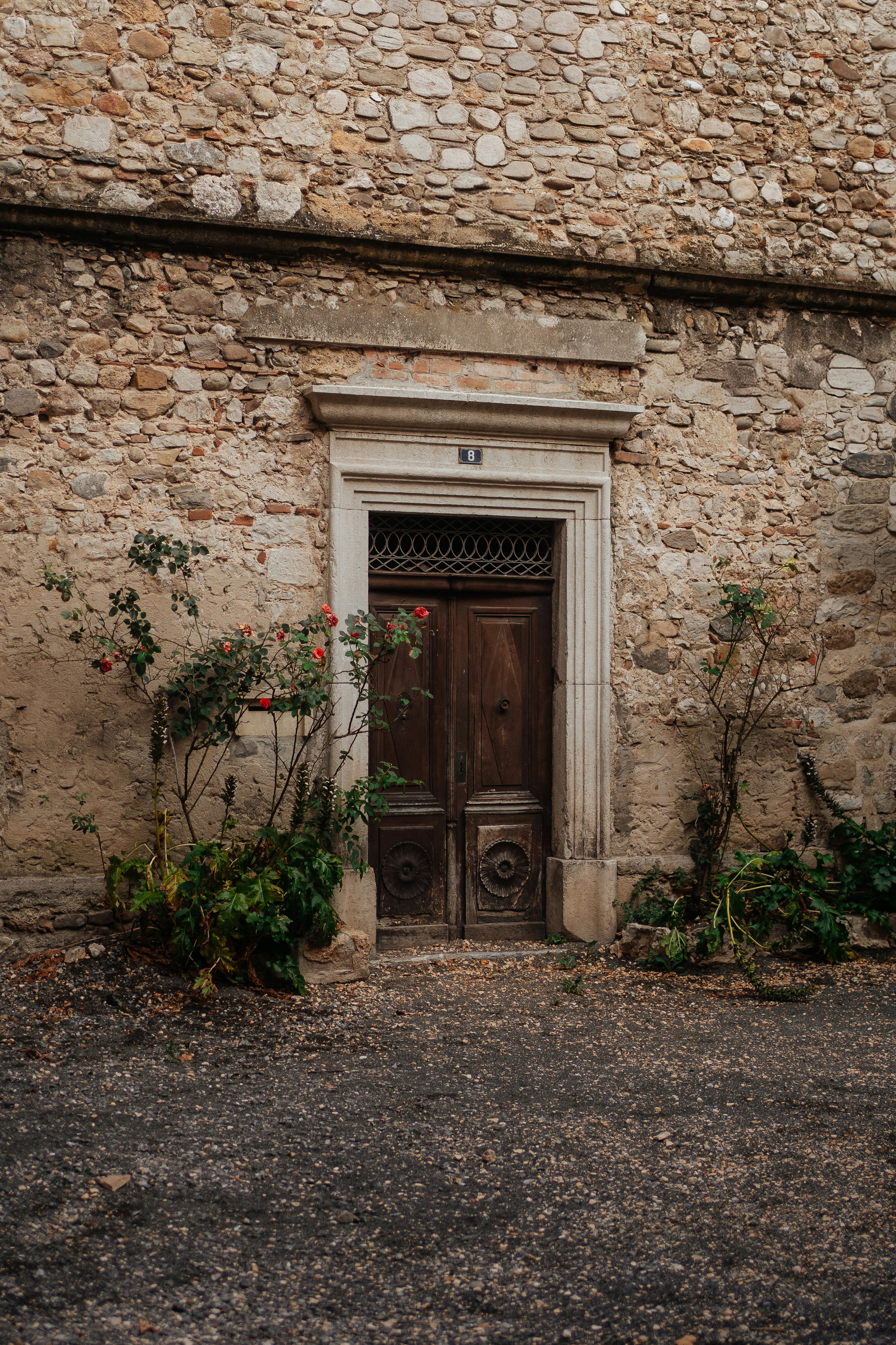 Old wooden door set in a stone wall