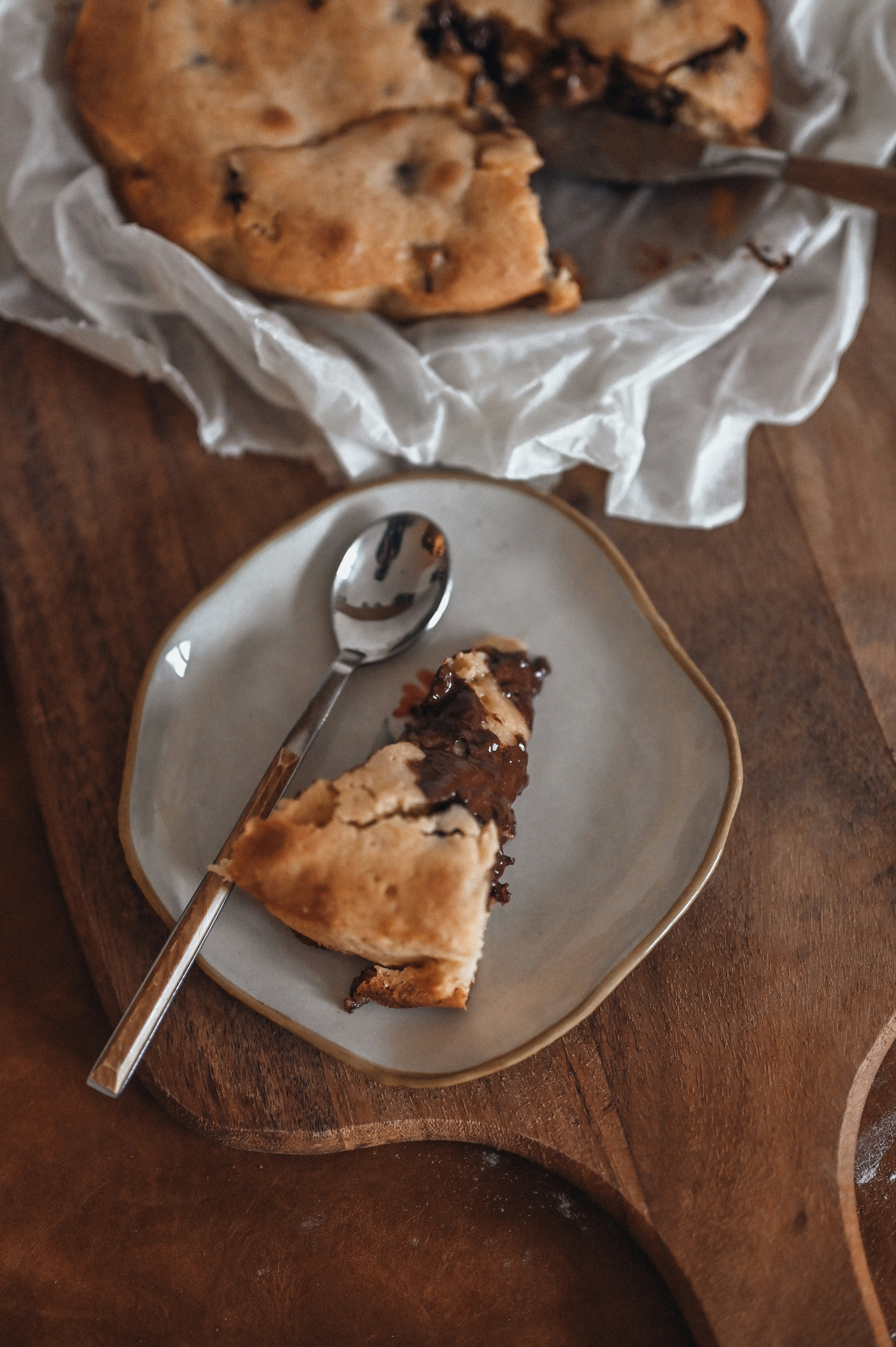 A slice of chocolate chip cake on a plate.