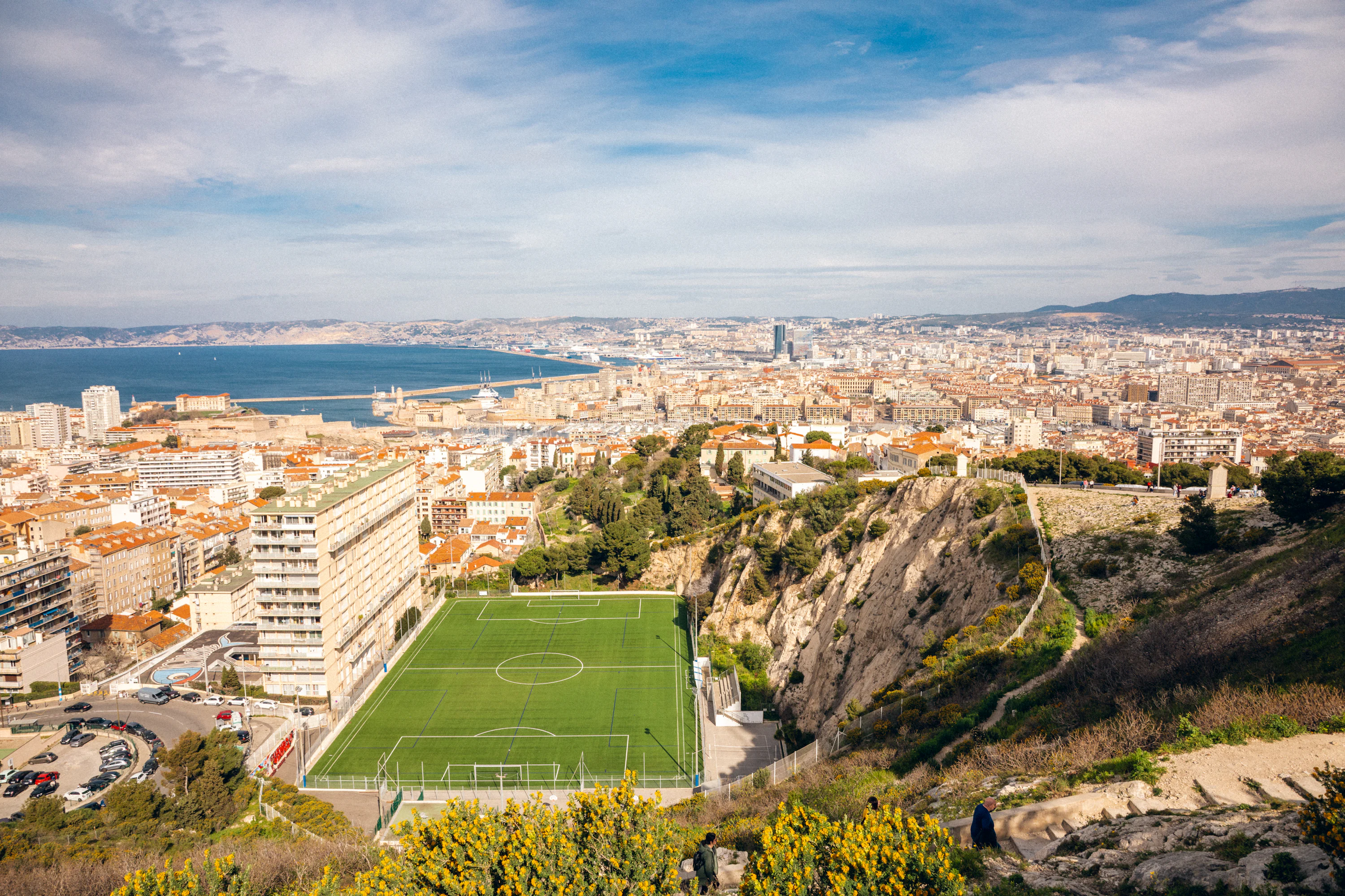 Soccer field overlooking a coastal city and ocean