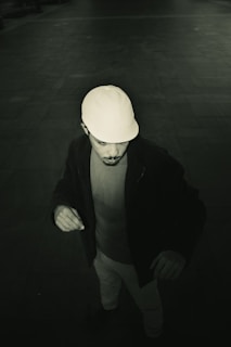 Man wearing a baseball cap looking down