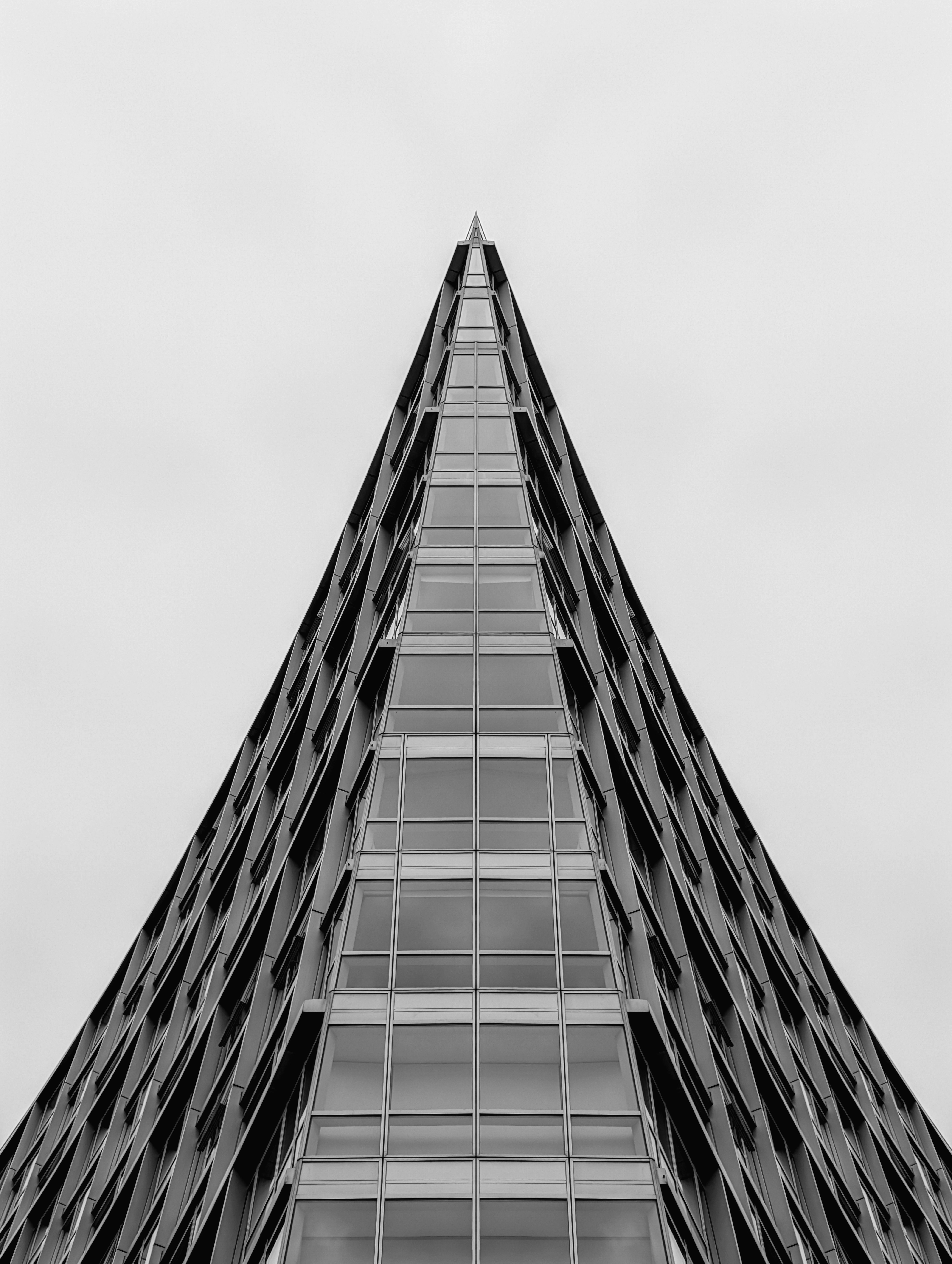 Modern skyscraper with glass windows against sky