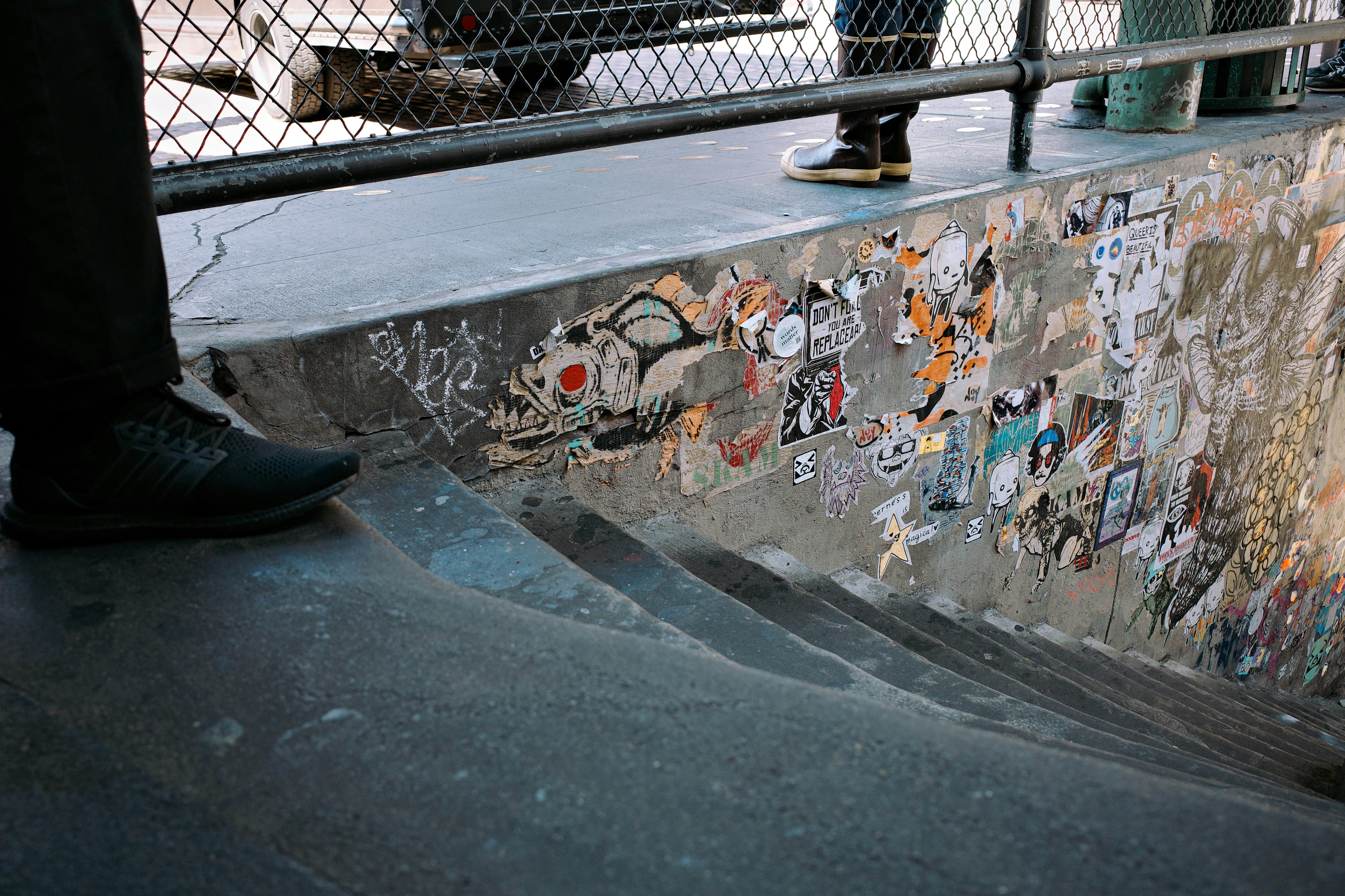 Skate park bowl with graffiti and people watching people
