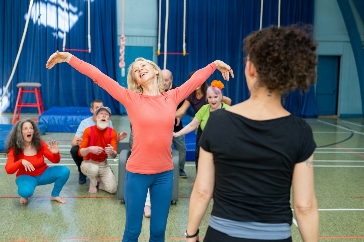 Children practicing circus arts in a gym, engaging in team-building gym activities and fun PE class games.