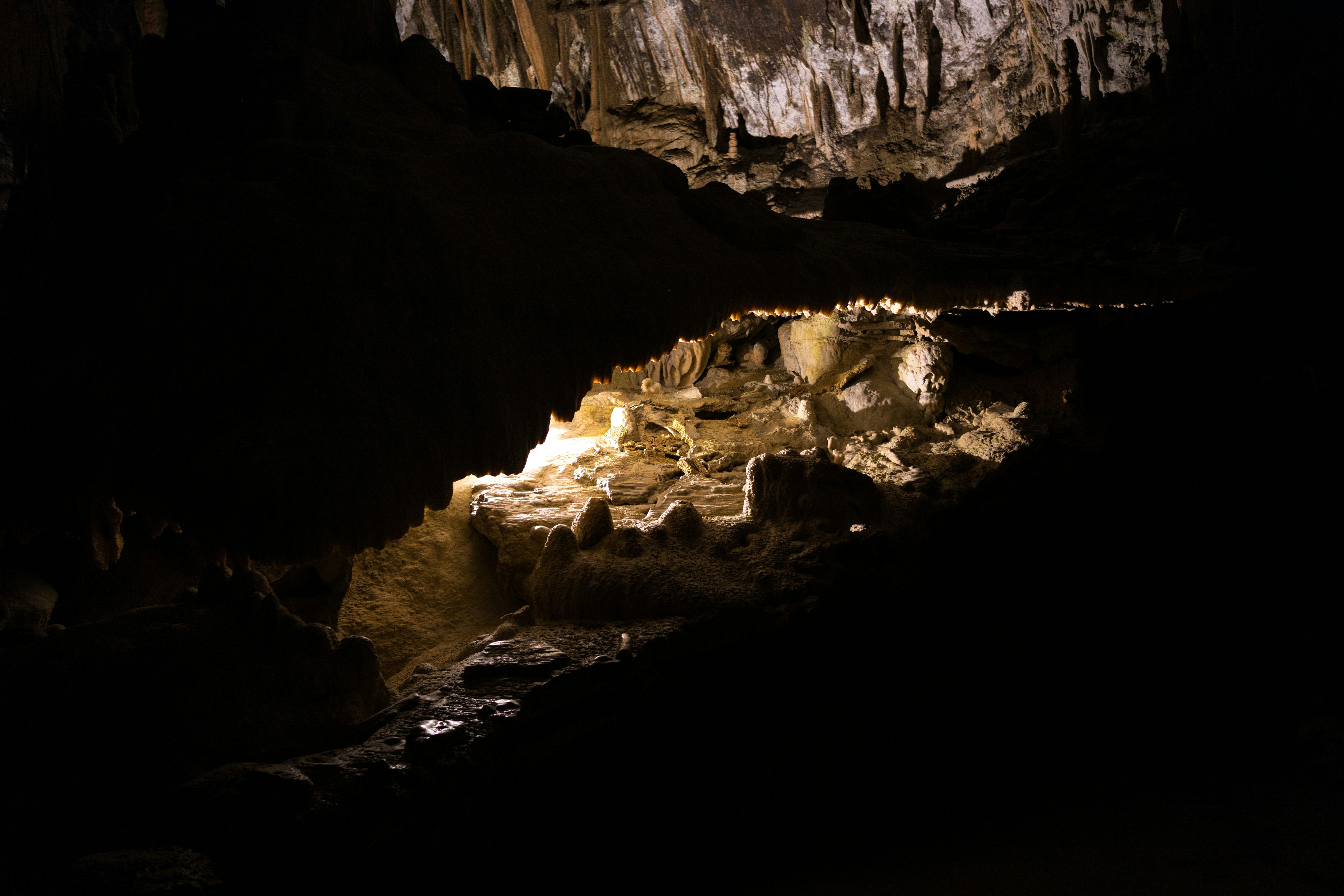 Illuminated cave formations with stalactites and stalagmites