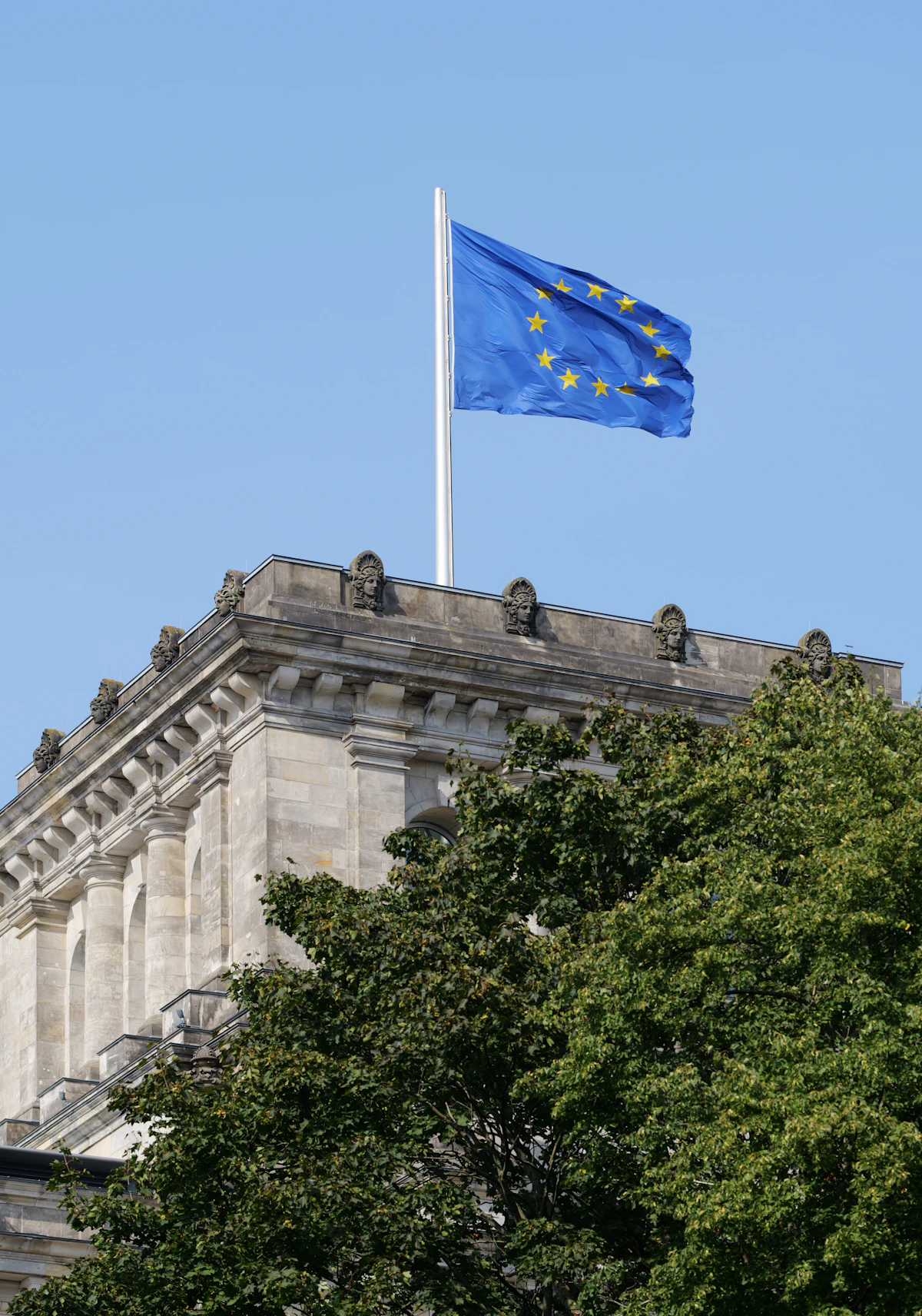European Union flag flying over a stone building