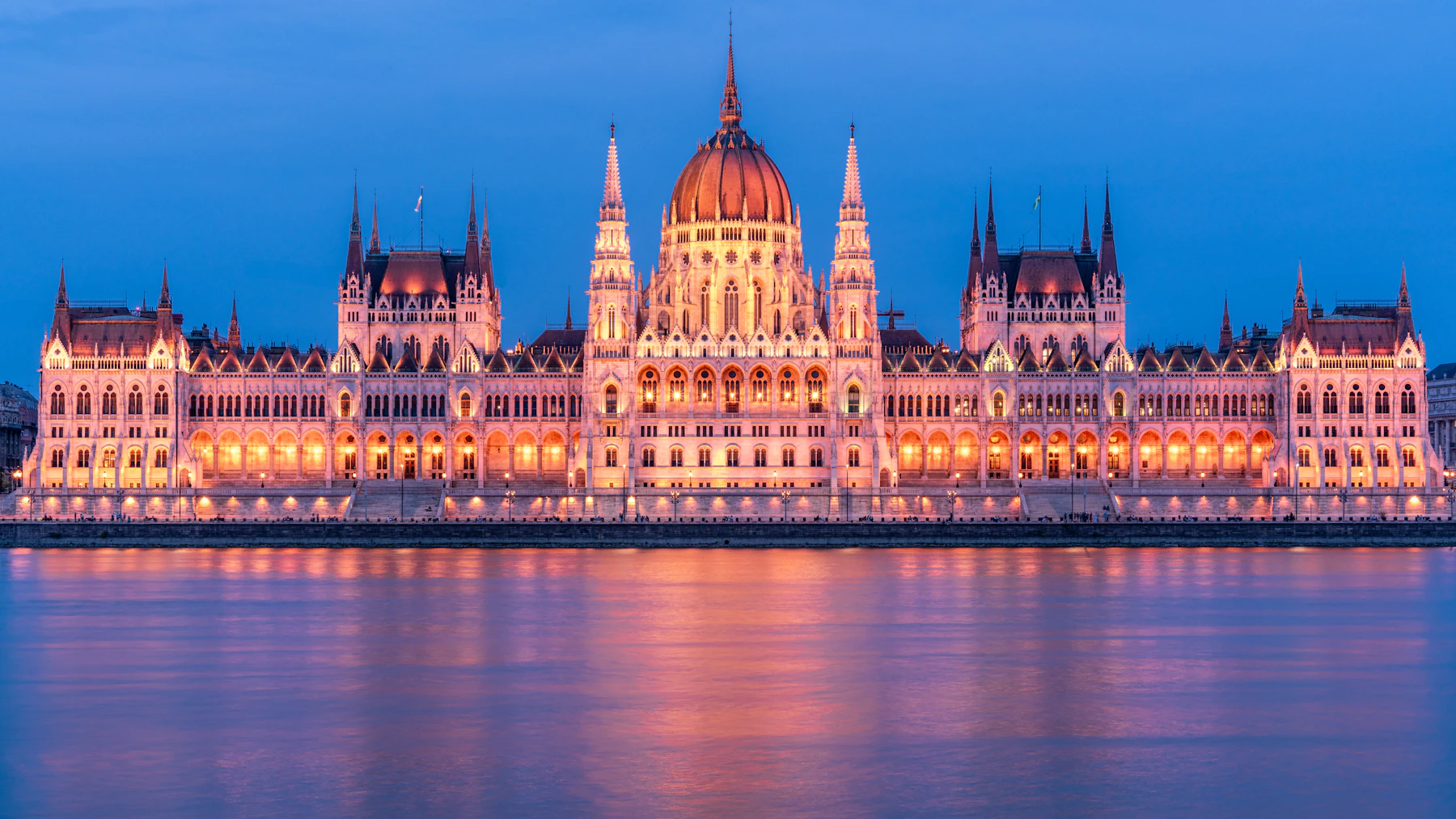Budapest's illuminated Hungarian Parliament Building reflected in the Danube at blue hour