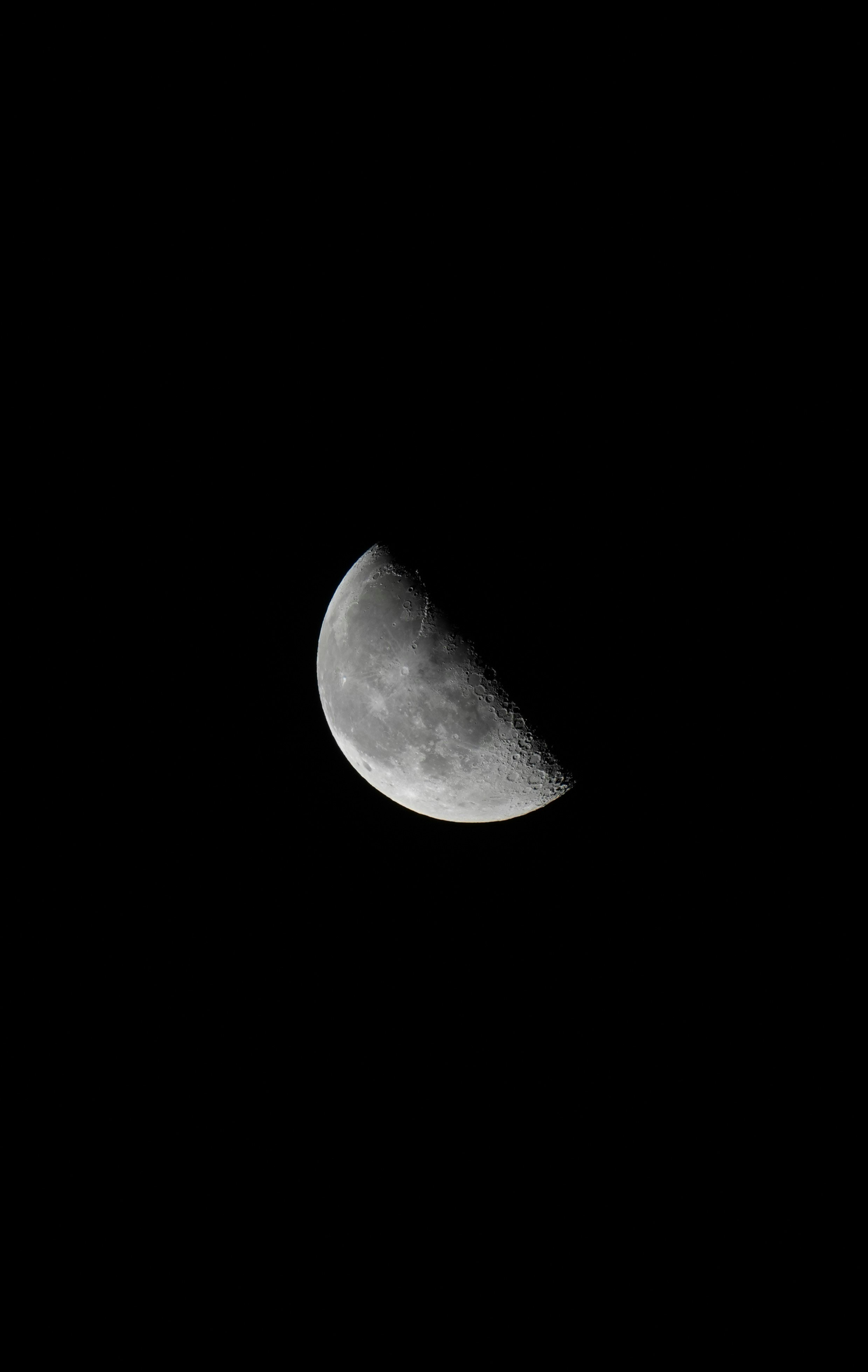 Half moon against a pitch-black sky
