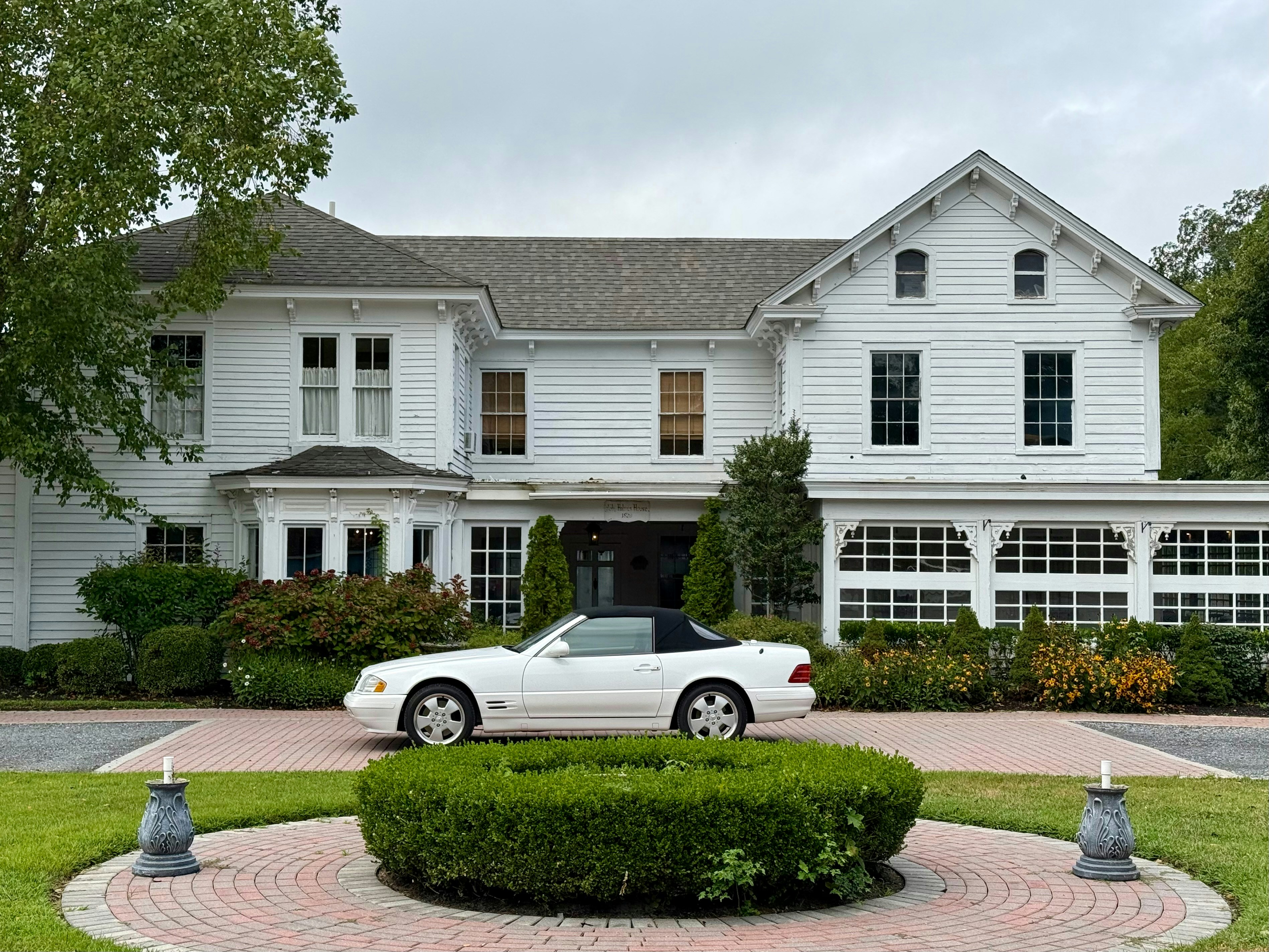 White convertible at luxury home