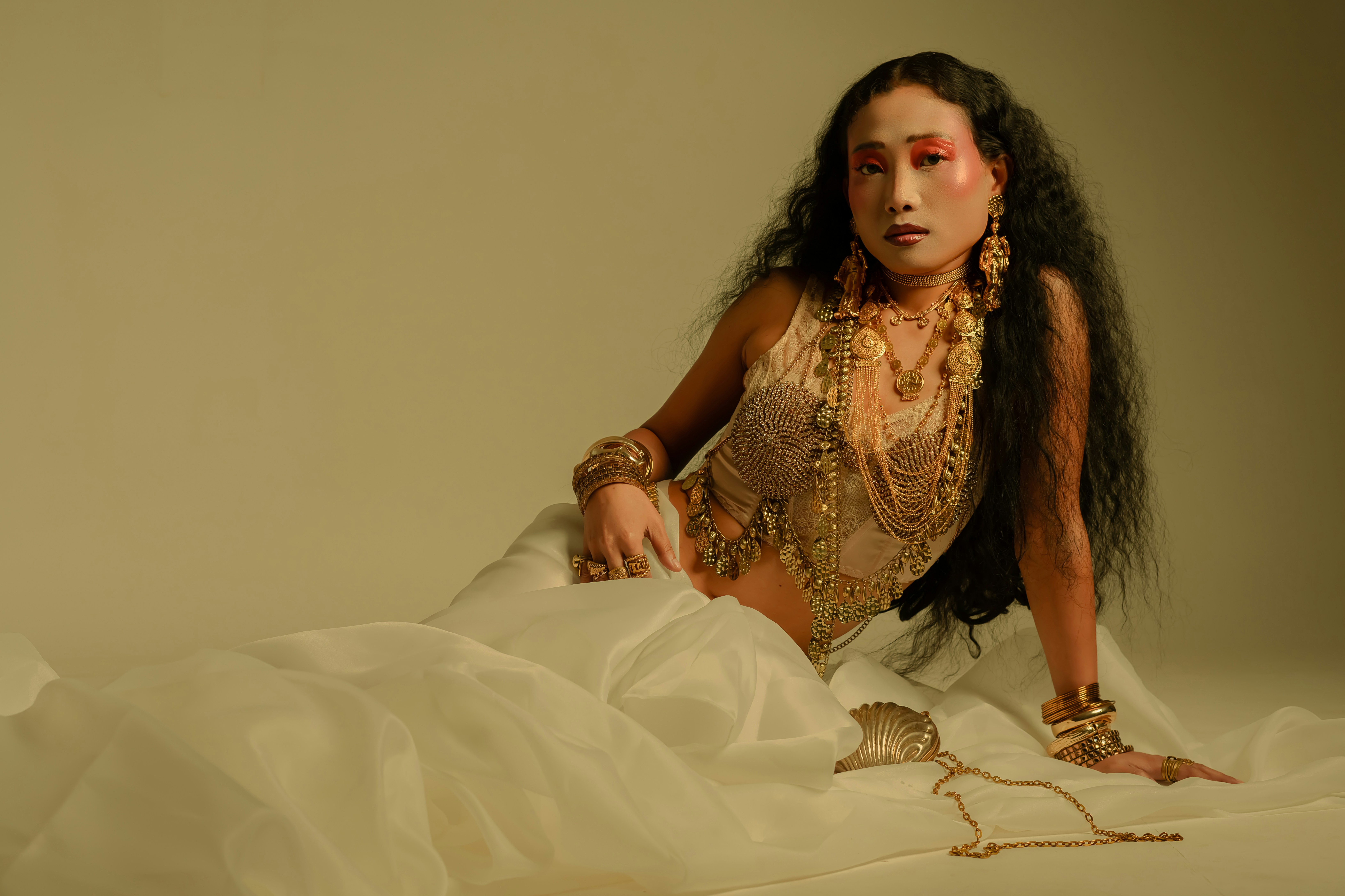 Woman in ornate jewelry and white dress