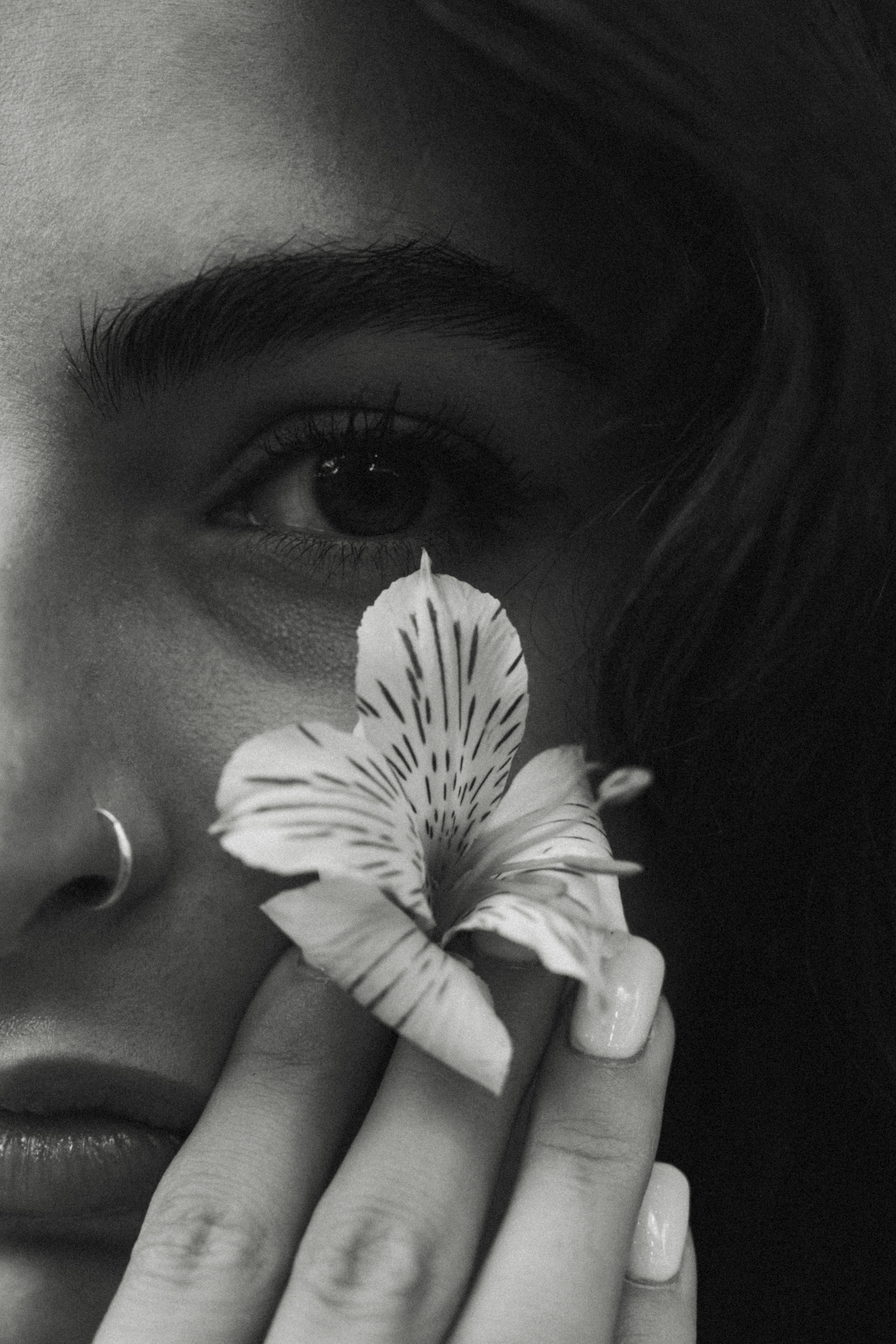 Woman holding a flower near her eye