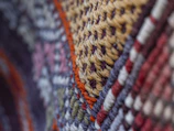 Close-up of colorful woven fabric with intricate patterns.