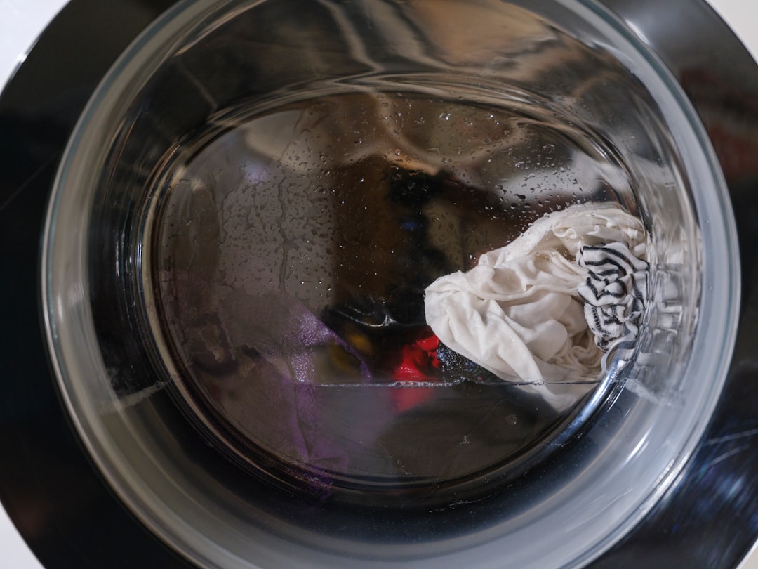 washing machine load close-up Washing machine drum with clothes and water