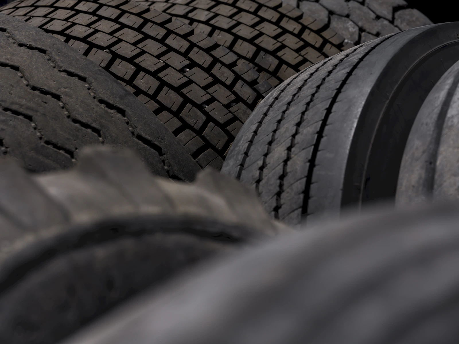 Close-up of several automotive tires and tread patterns