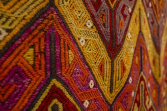 Close-up of a colorful woven textile with geometric patterns.