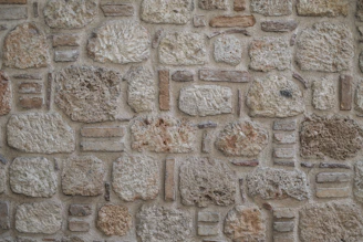 Rough textured stone wall with varied stones and irregular blocks