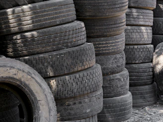Stacks of old used car tires piled up