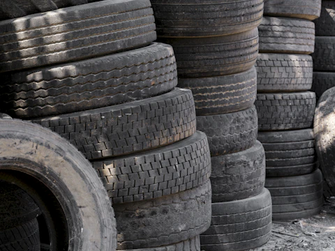 Stacks of old used car tires piled up