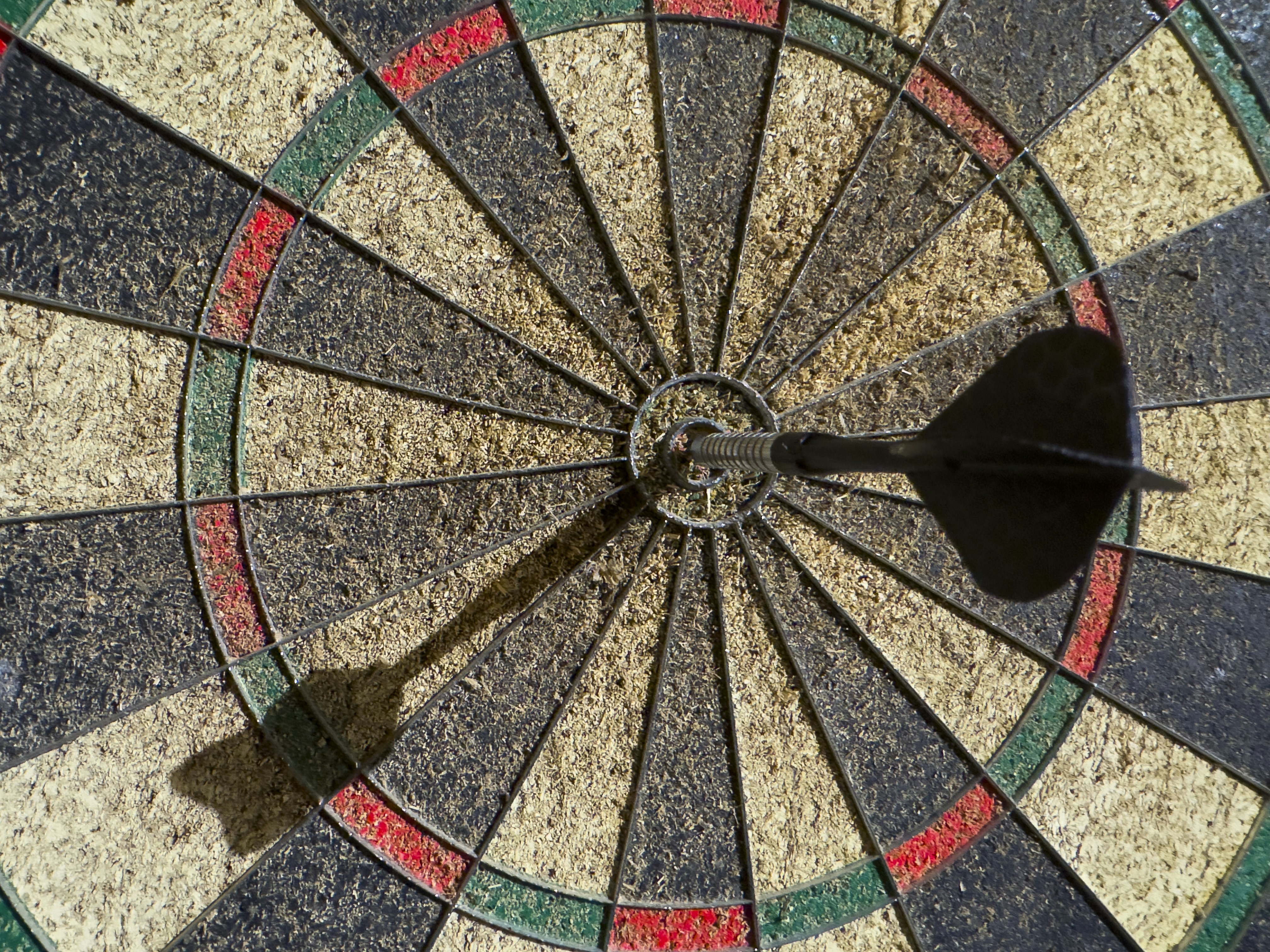 Dartboard with a dart in the bullseye