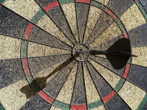 Dartboard with a dart in the bullseye