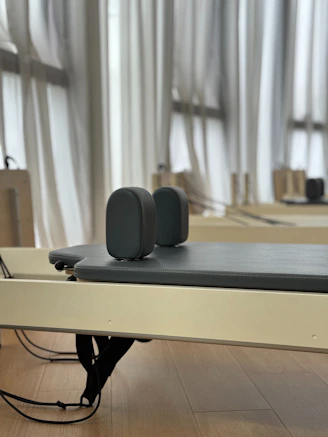 Pilates reformer with padded headrest and straps