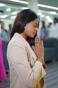 Woman praying with hands together