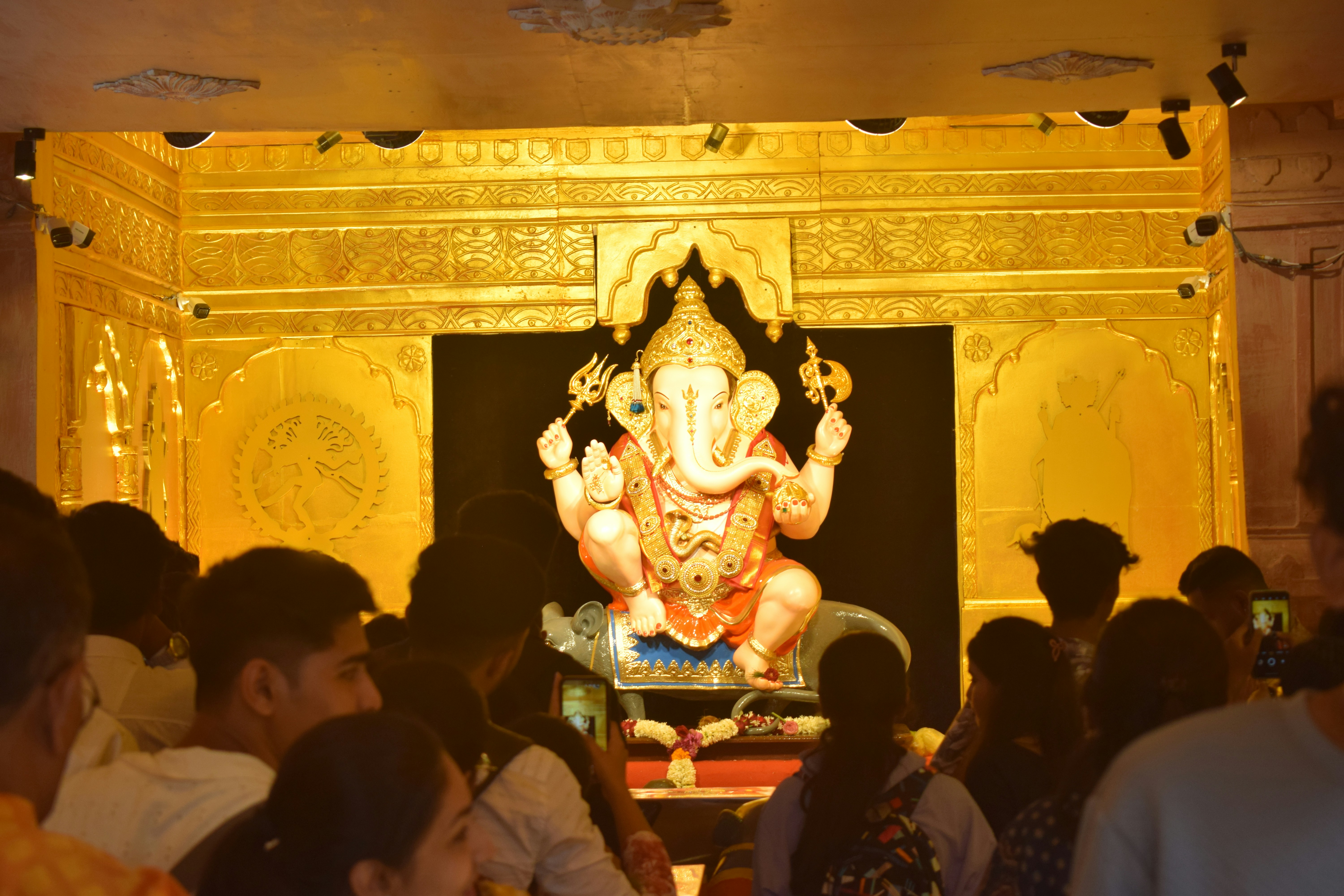 People gather to see a large ganesh statue.