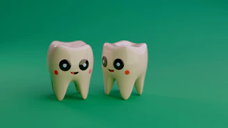 Two cartoon teeth smiling on a green background