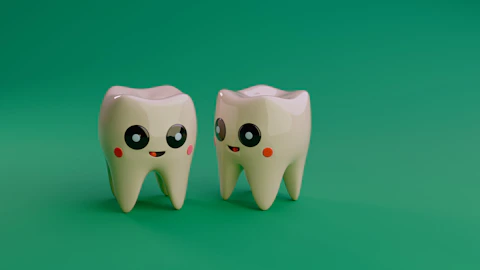 Two cartoon teeth smiling on a green background