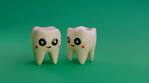 Two cartoon teeth smiling on a green background