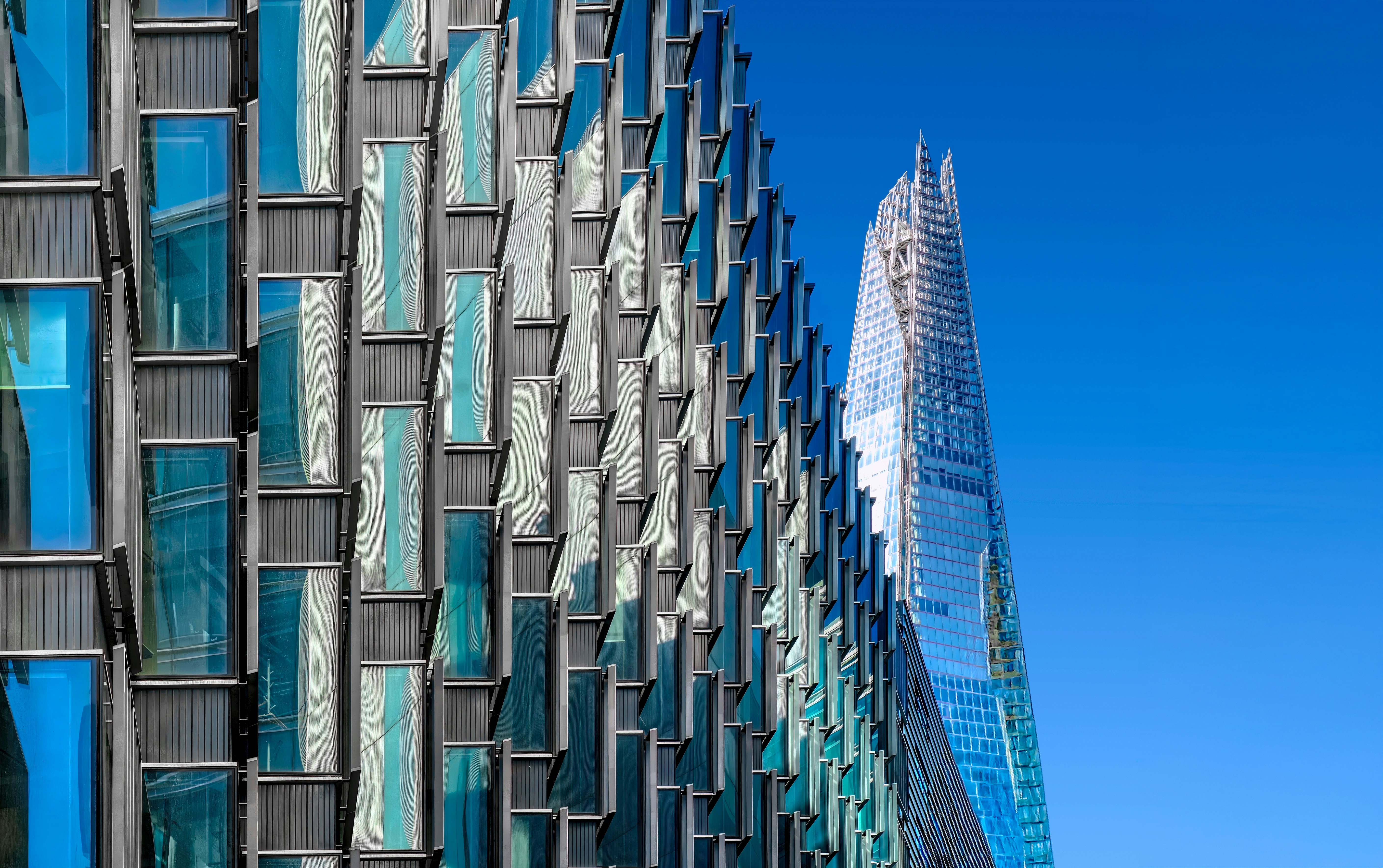 Modern glass buildings against a clear blue sky