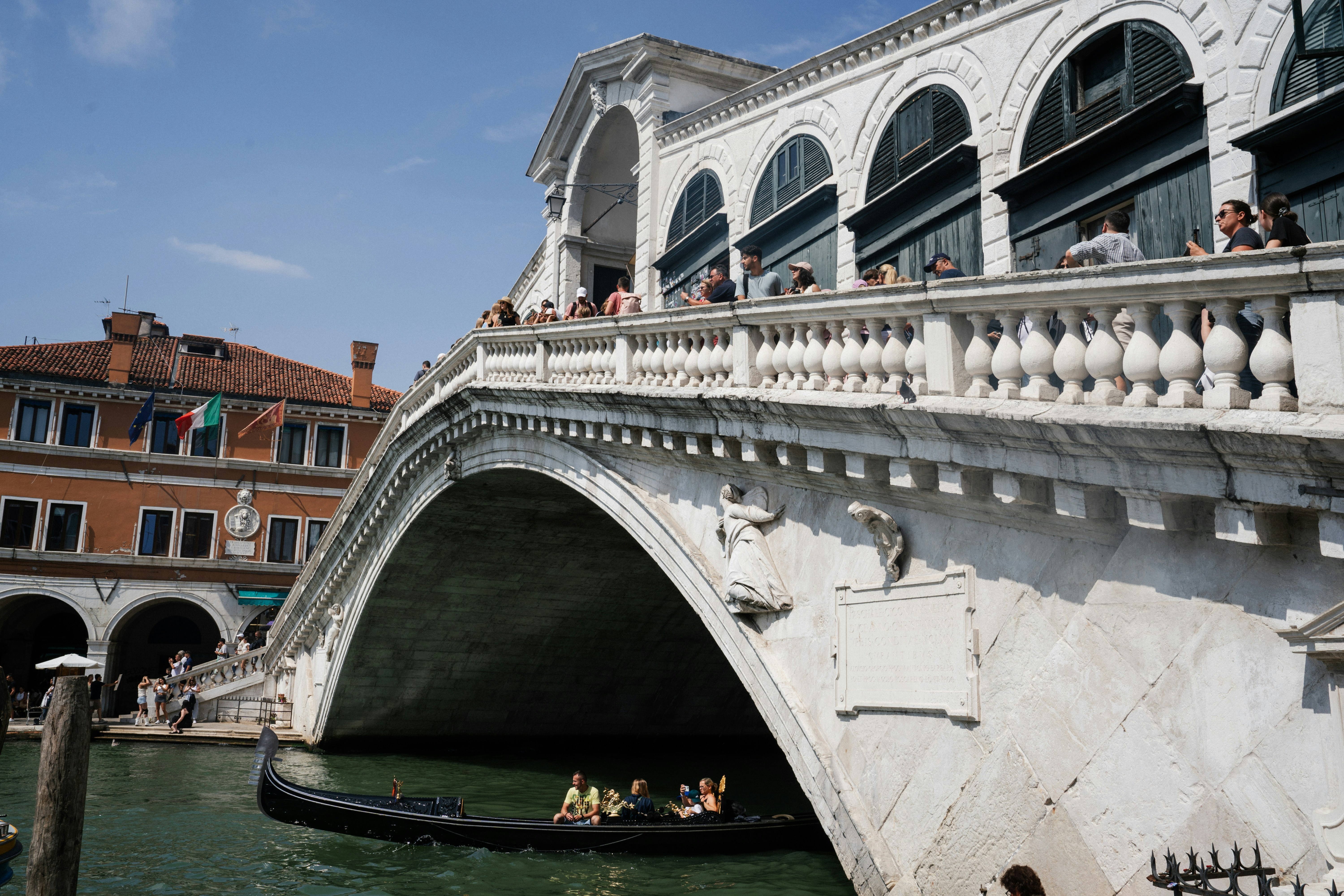 Rialto bridge over a canal in venice with gondola